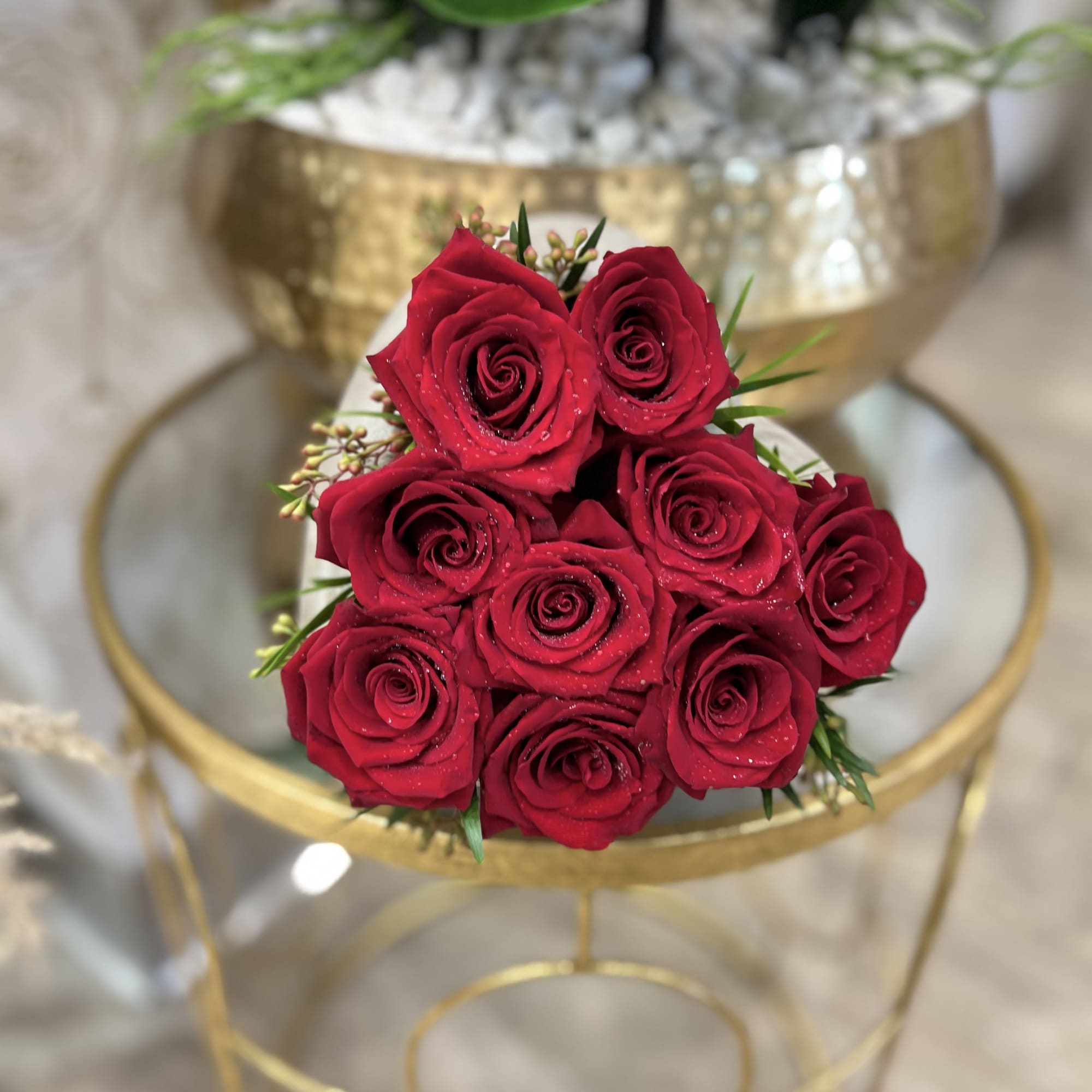 Red rose bouquet with a gold stand in the background
