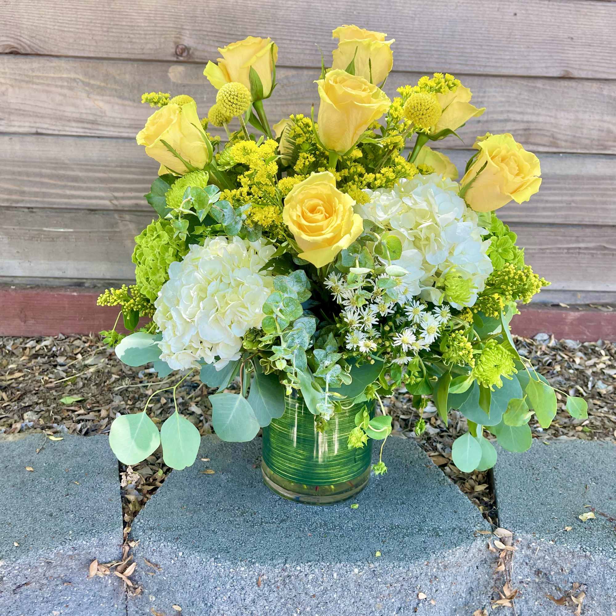 Yellow roses and white hydrangeas in a glass vase, photo 2 of 3