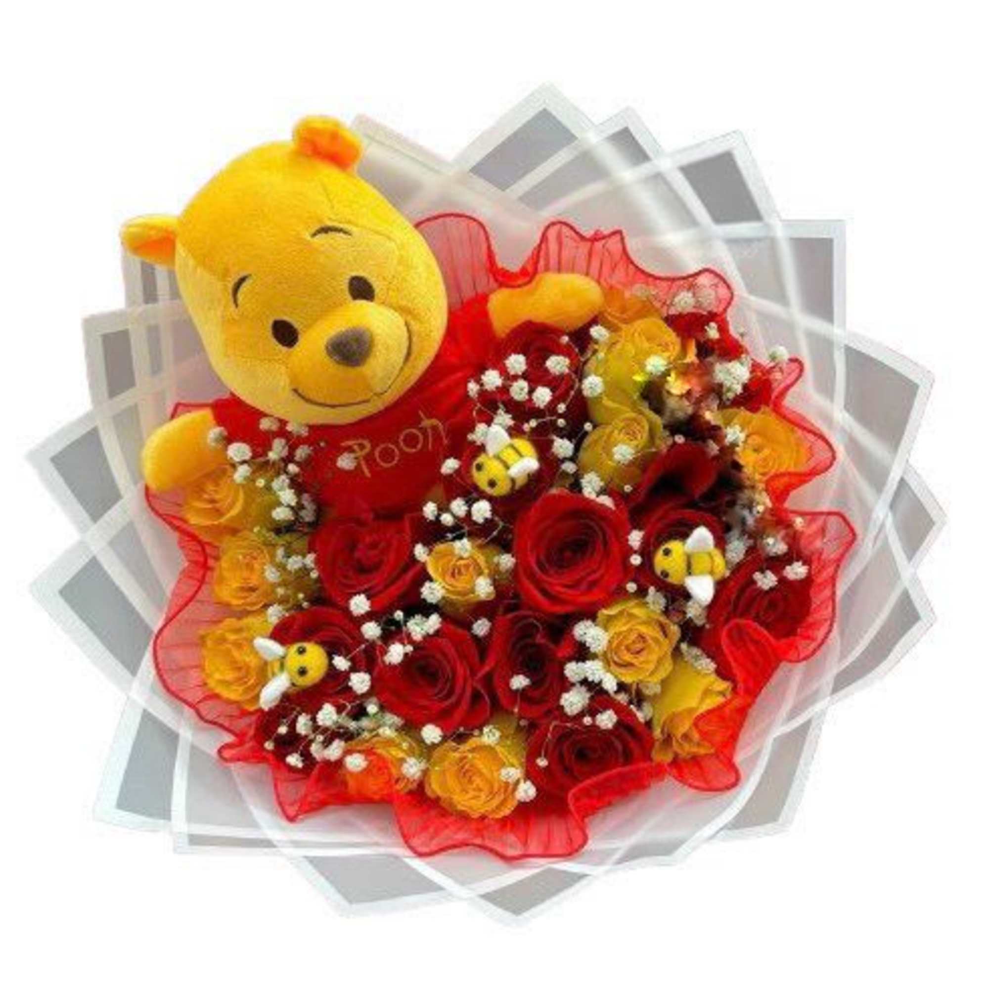 Bouquet of red and yellow roses with a Winnie the Pooh plush