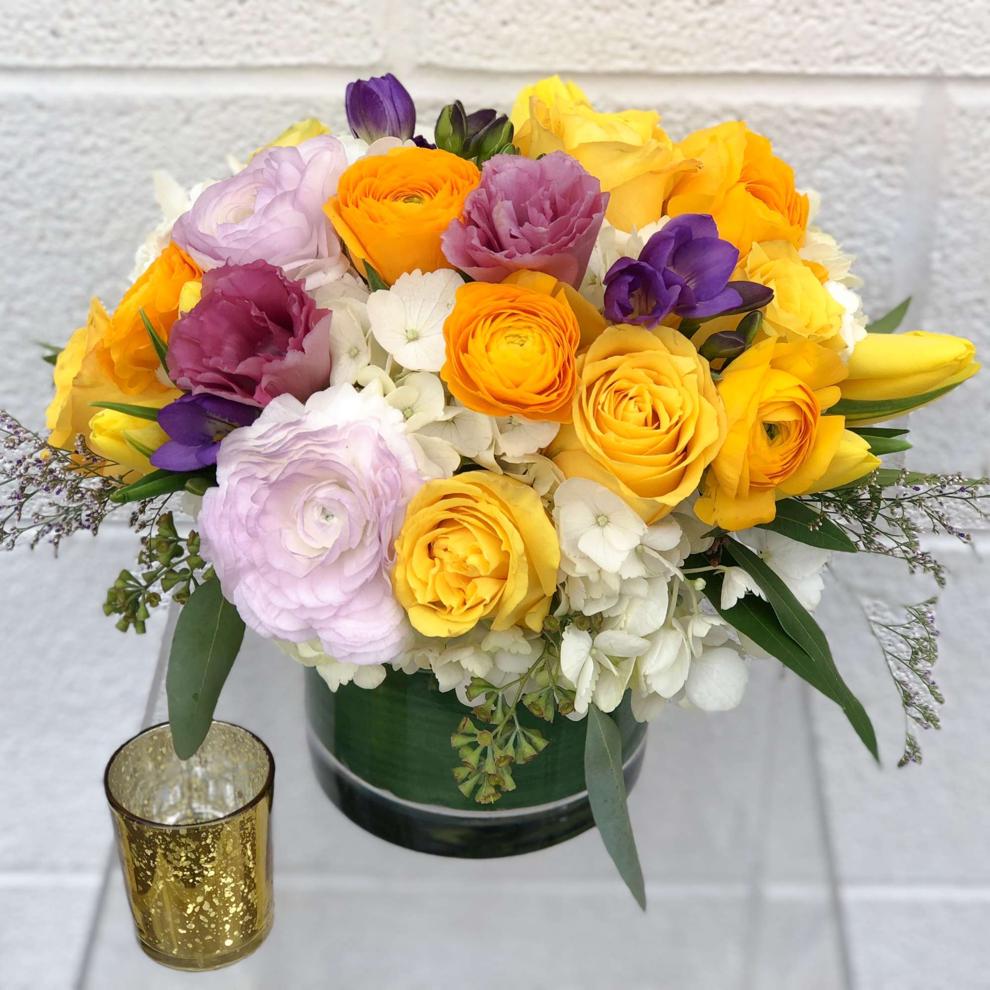 This beautiful designer's choice arrangement is filled with premium seasonal blooms. These