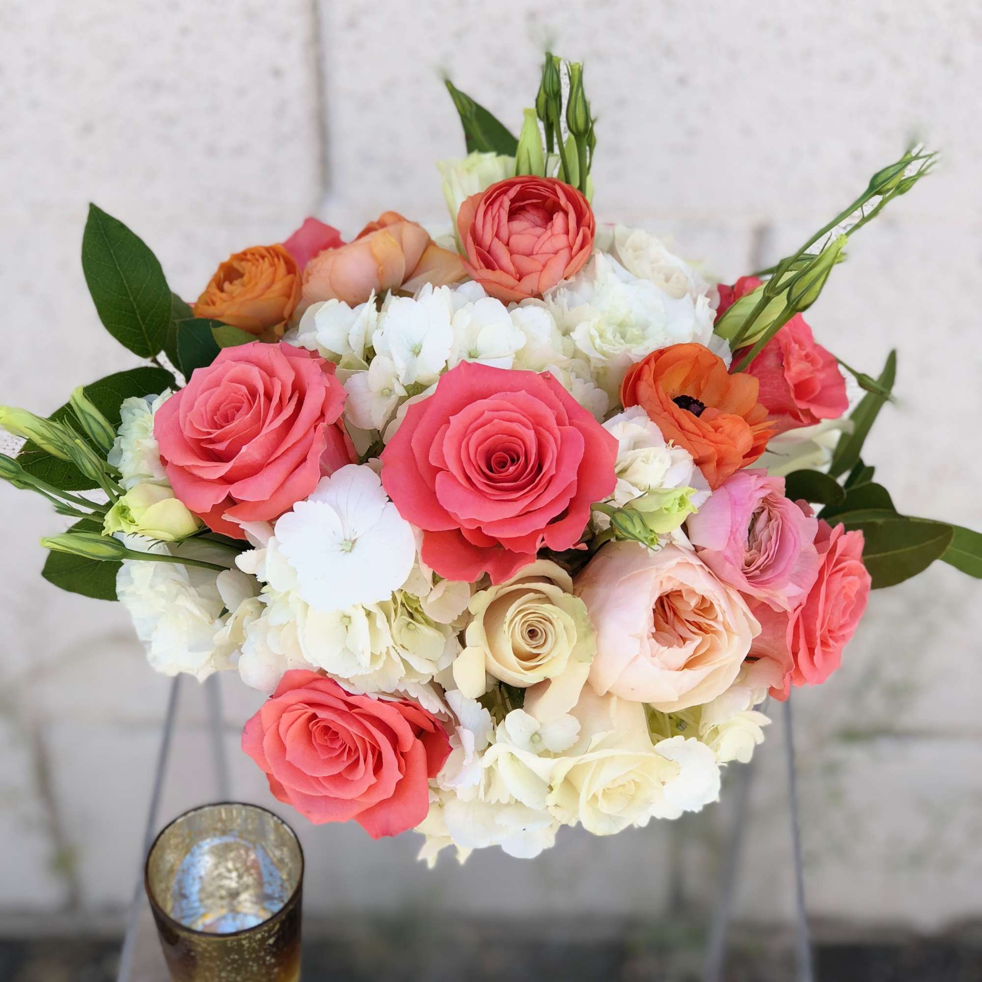 Variety of premium blooms in a glass vase.

This low and lush designer's