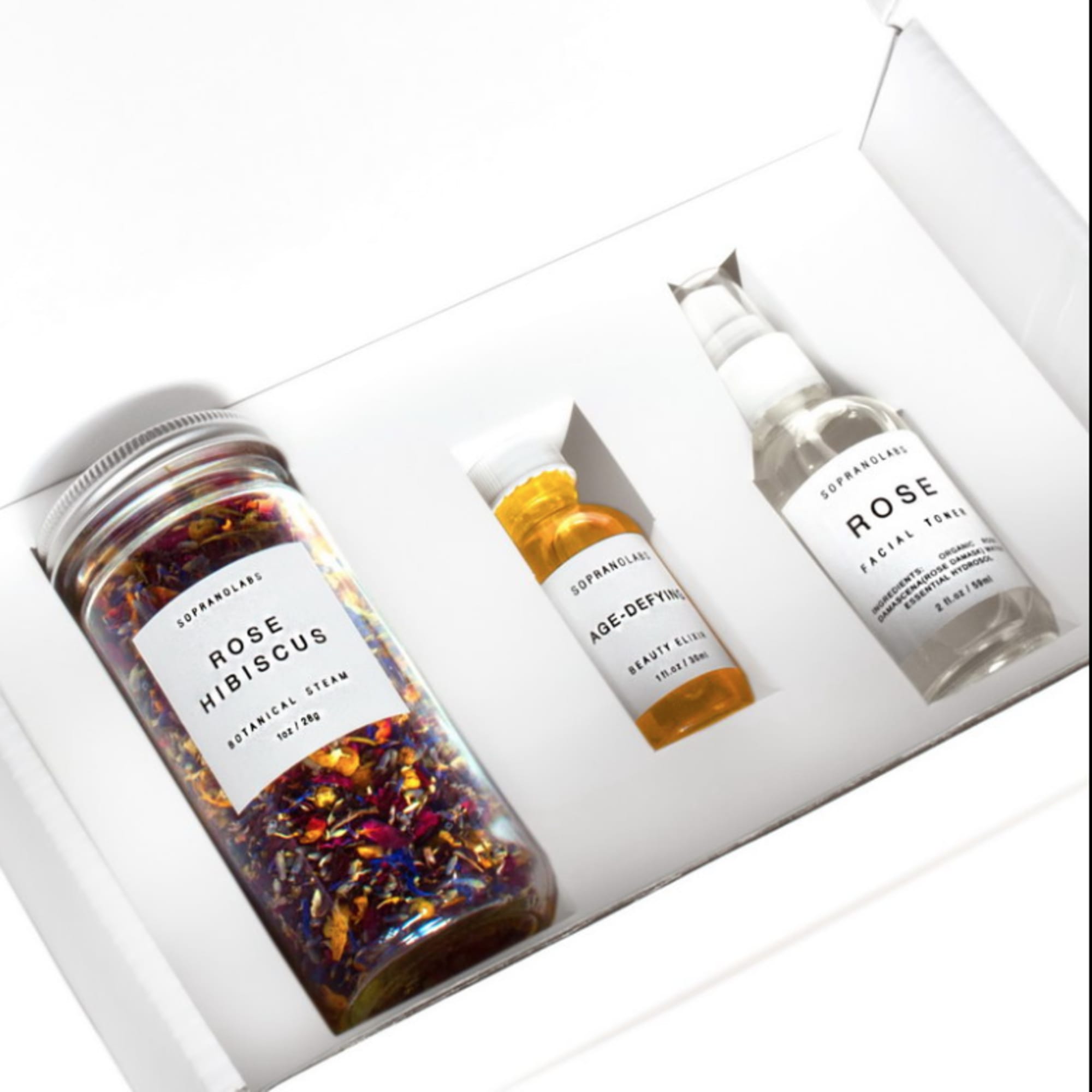 Gift box with rose hibiscus tea, age-defying oil, and rose facial toner