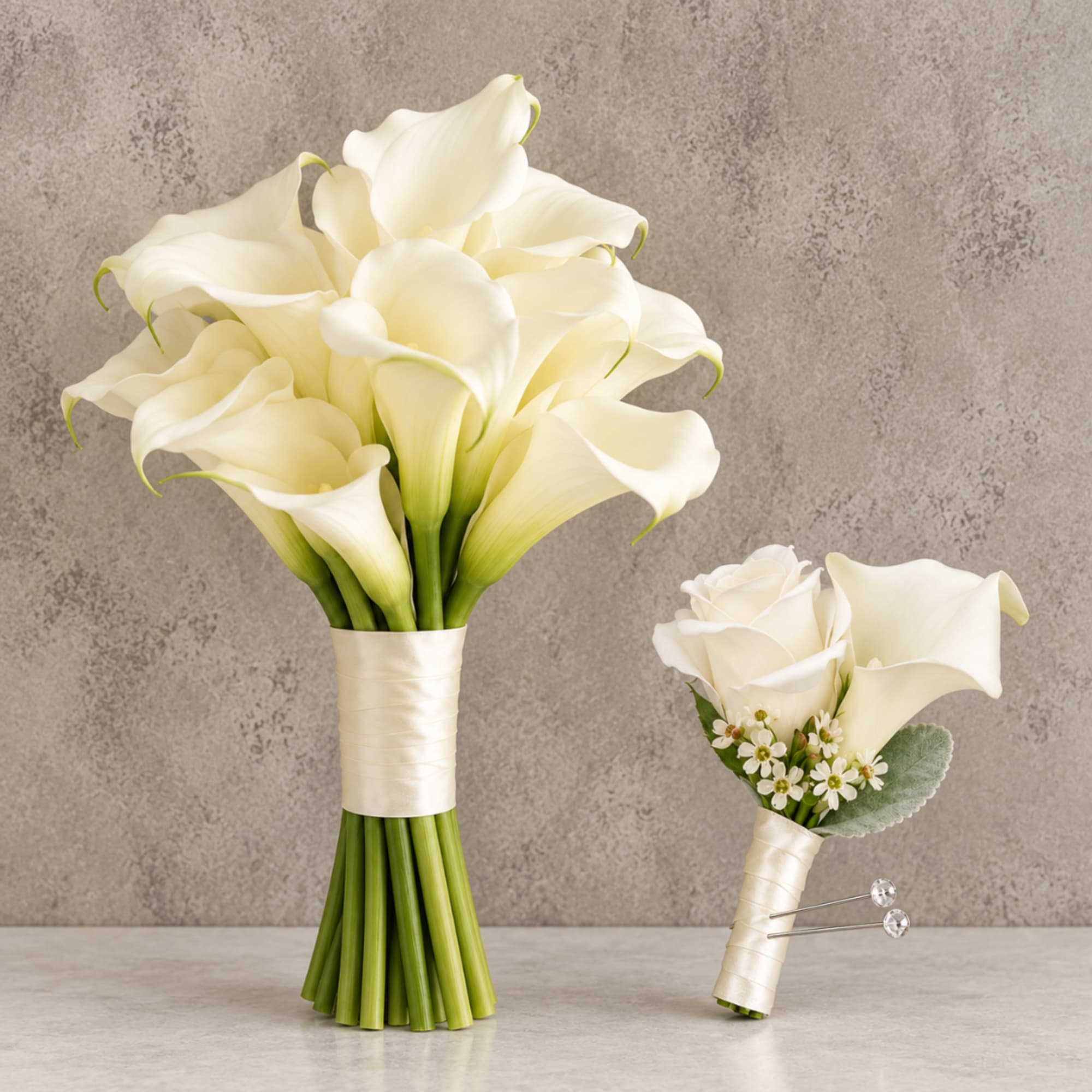 White calla lily bridal bouquet and matching boutonniere on a neutral background