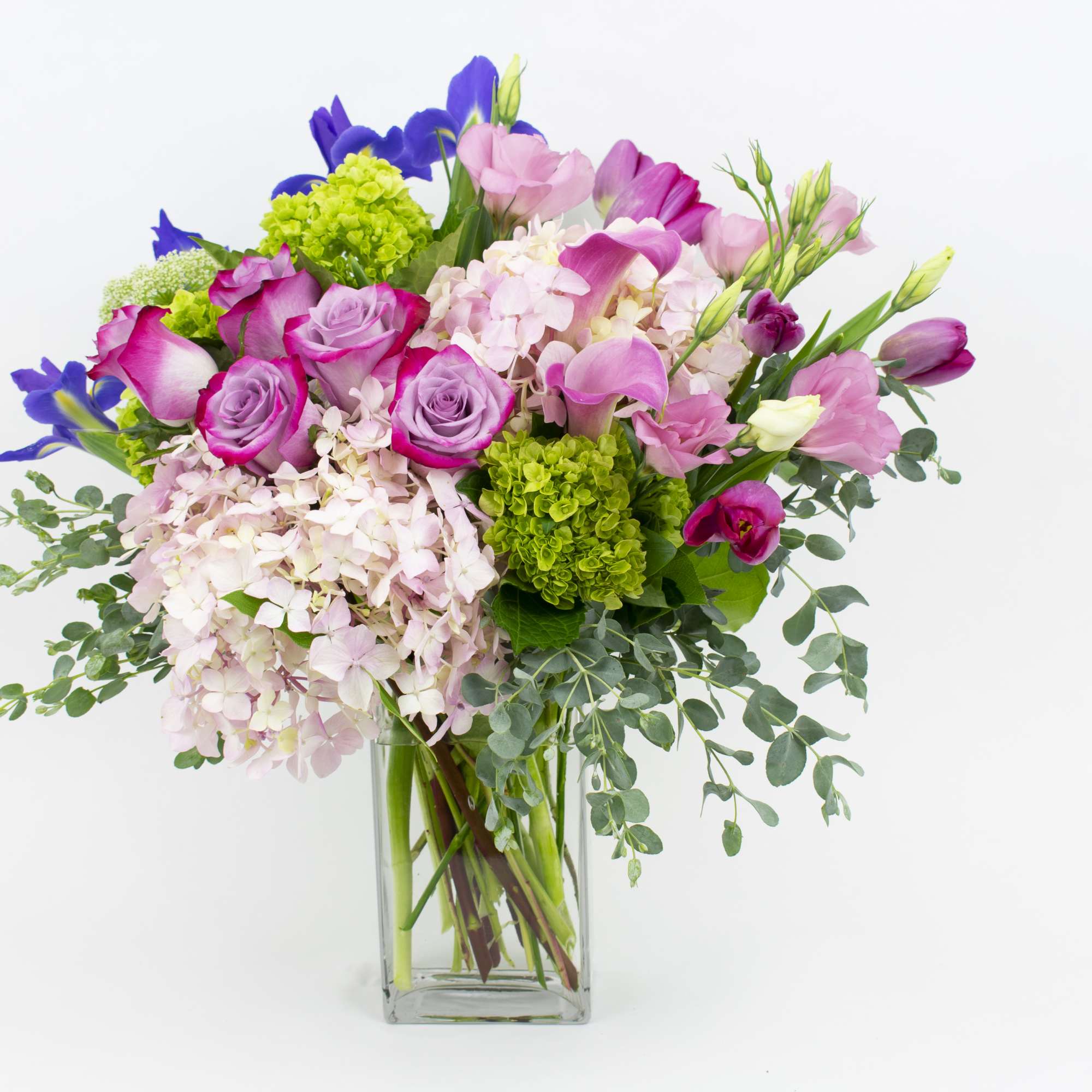 Bouquet of pink and purple flowers in a clear glass vase
