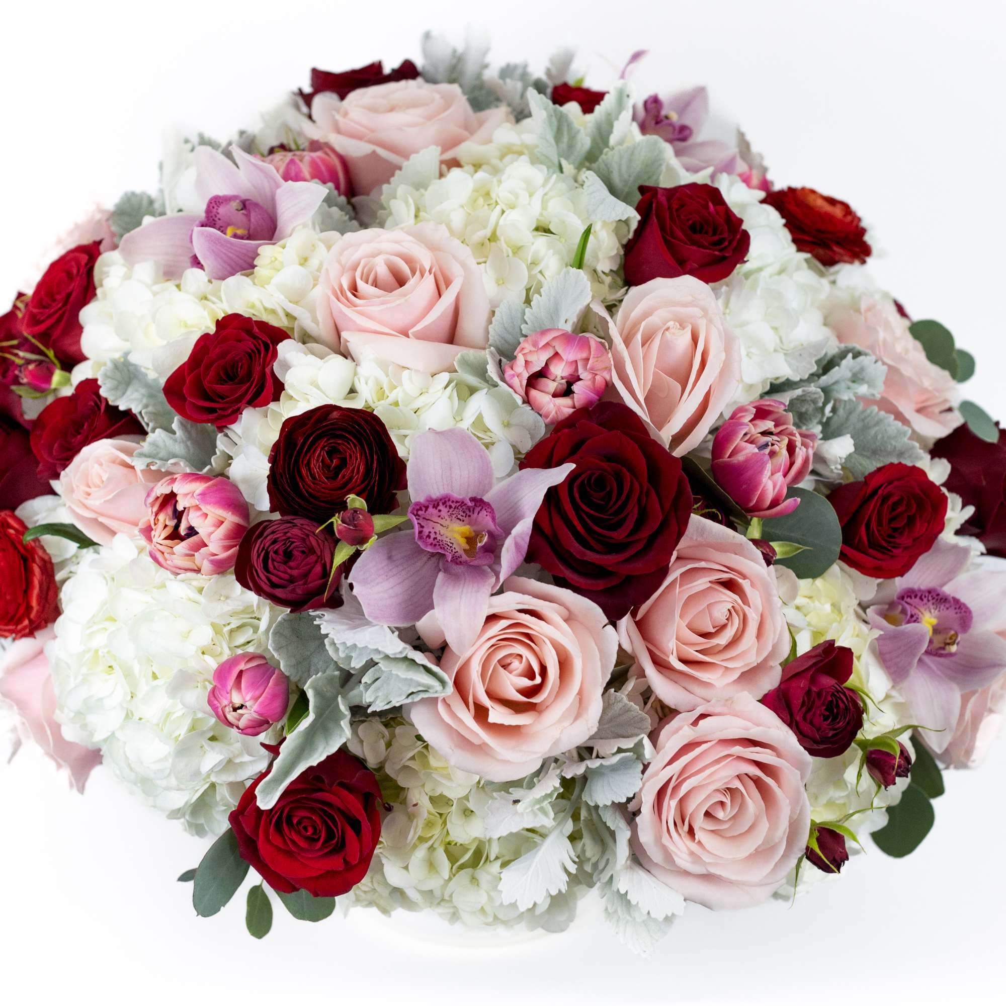 Round bouquet of pink and red roses with white blooms