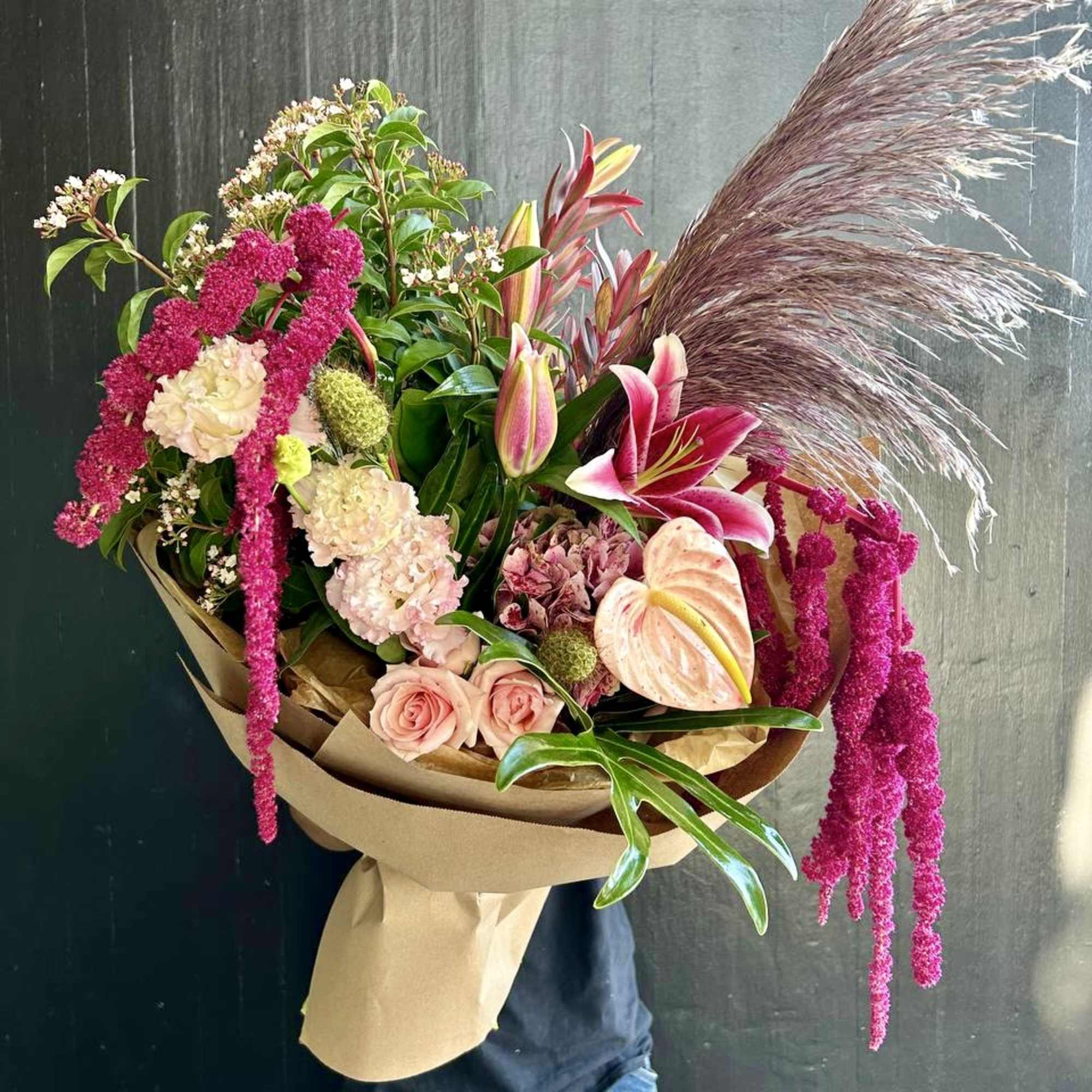 Large bouquet with pink lilies, roses, and cascading magenta flowers