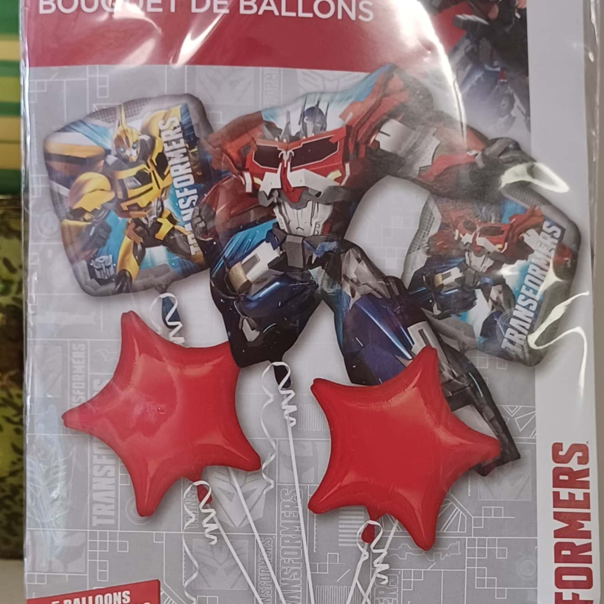 Package of Transformers-themed foil balloons with red star balloons