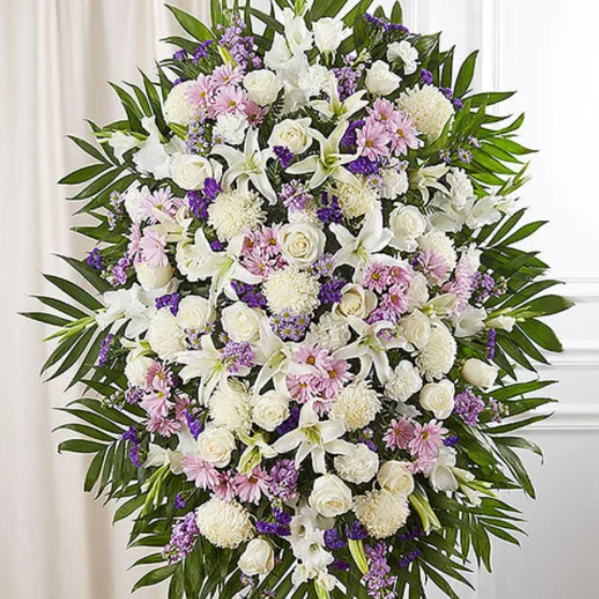 Standing floral spray of white, pink, and purple flowers on an easel