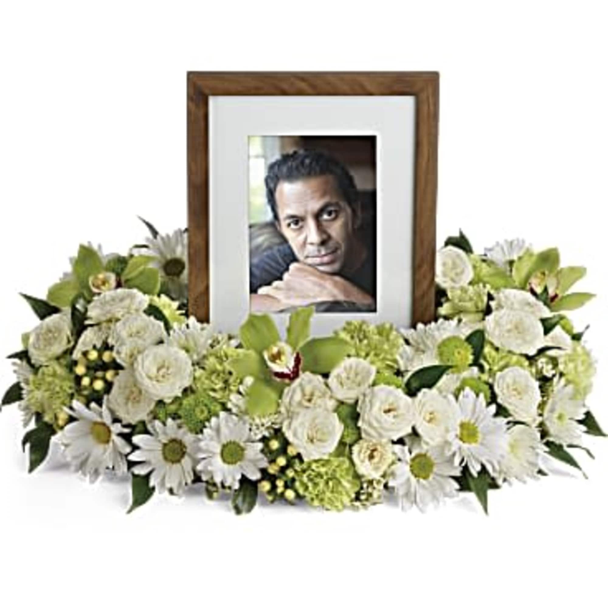 White floral photo frame arrangement with a portrait in the center