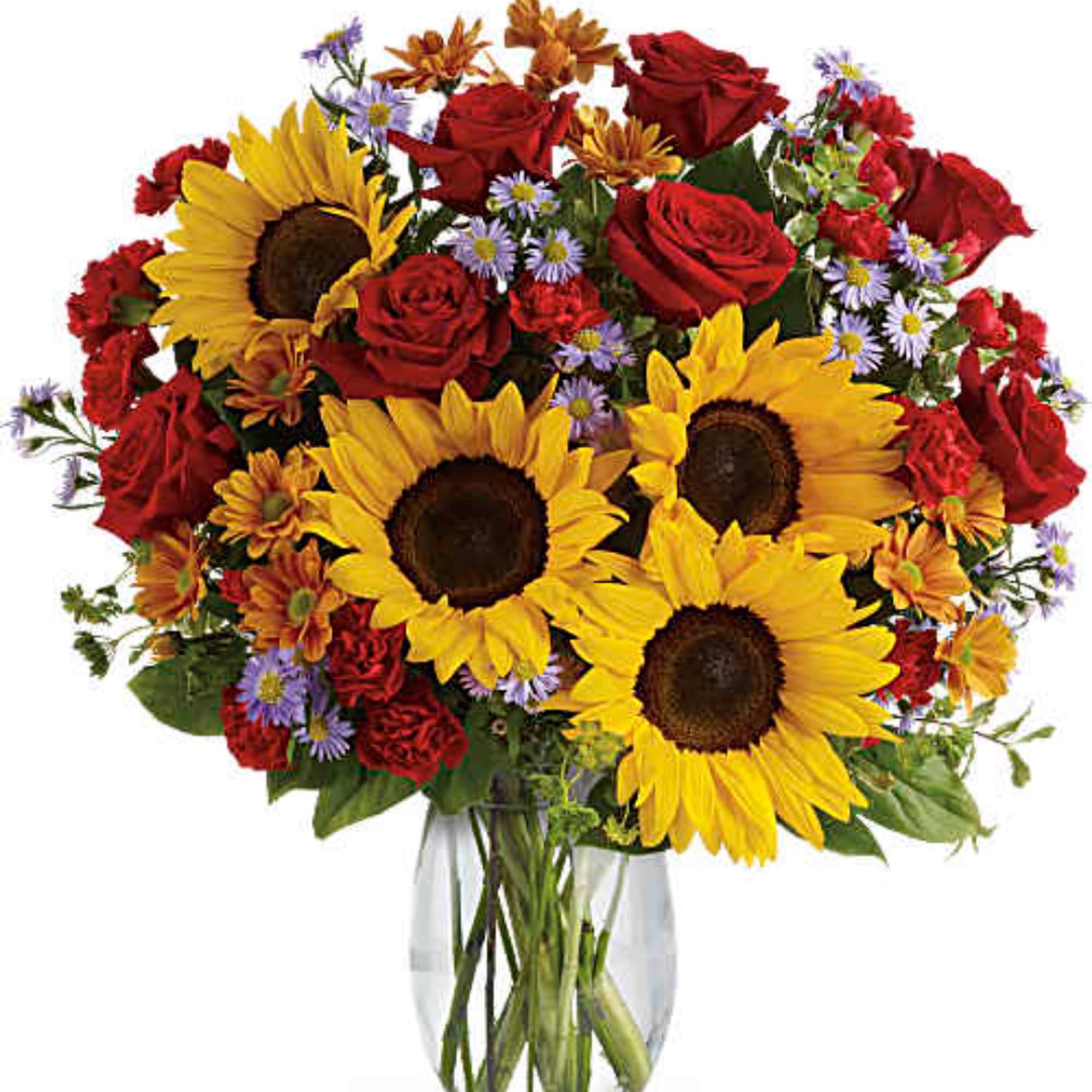 Bouquet of sunflowers, red roses, and small purple flowers in a clear glass vase