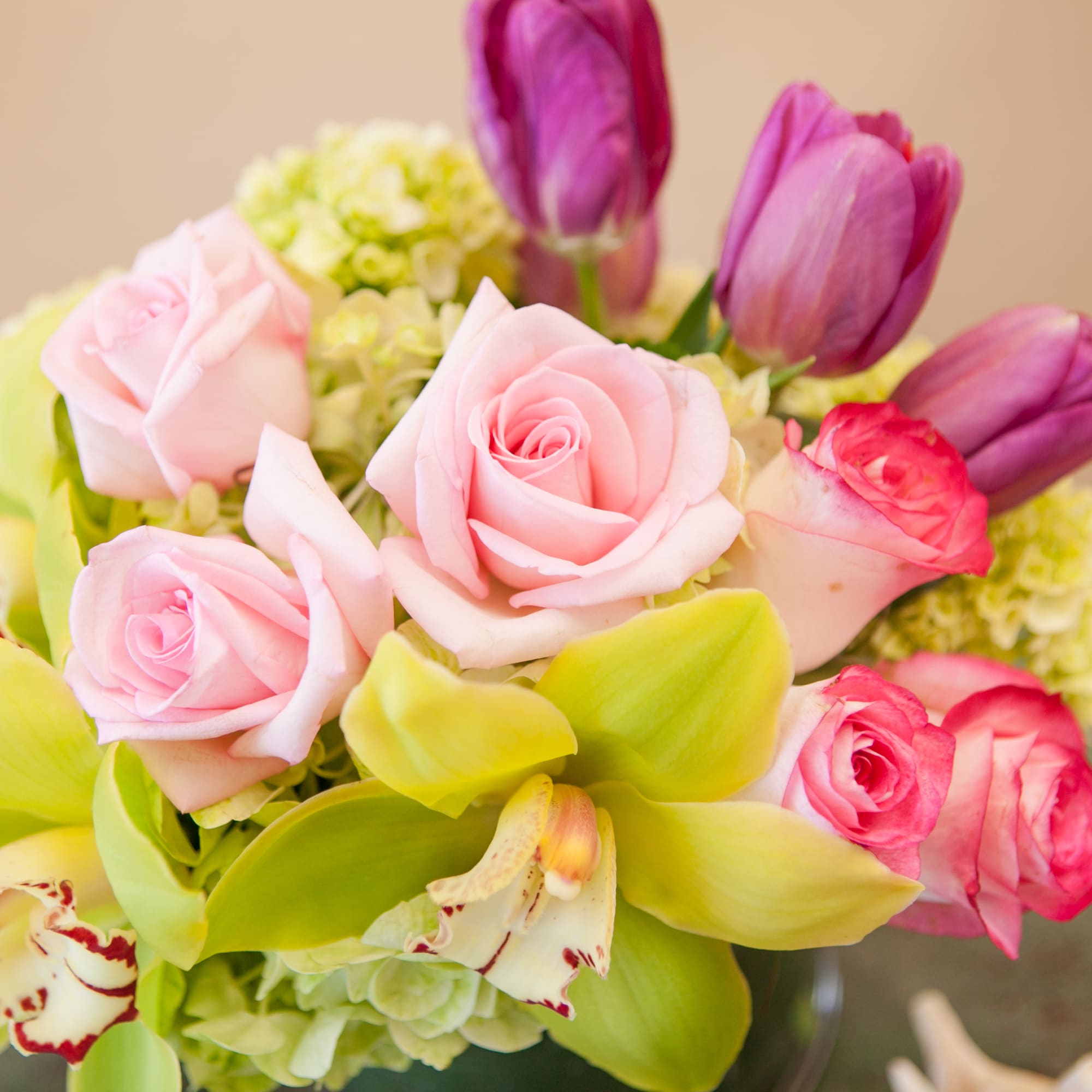 Bouquet of pink roses and purple tulips with green orchids