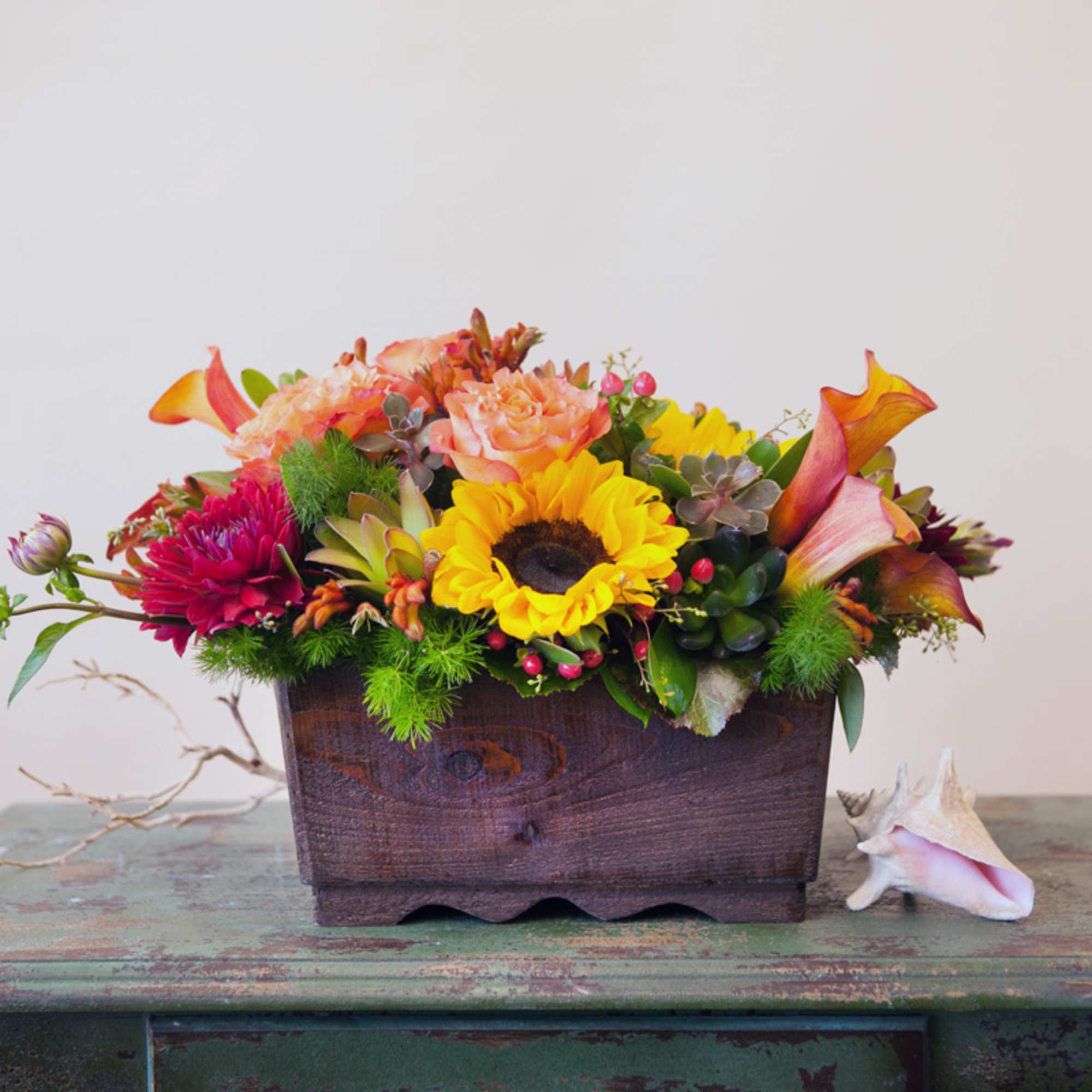 Stunning sunset colored flowers arranged in a large, reusable wooden container- including, photo 2 of 2