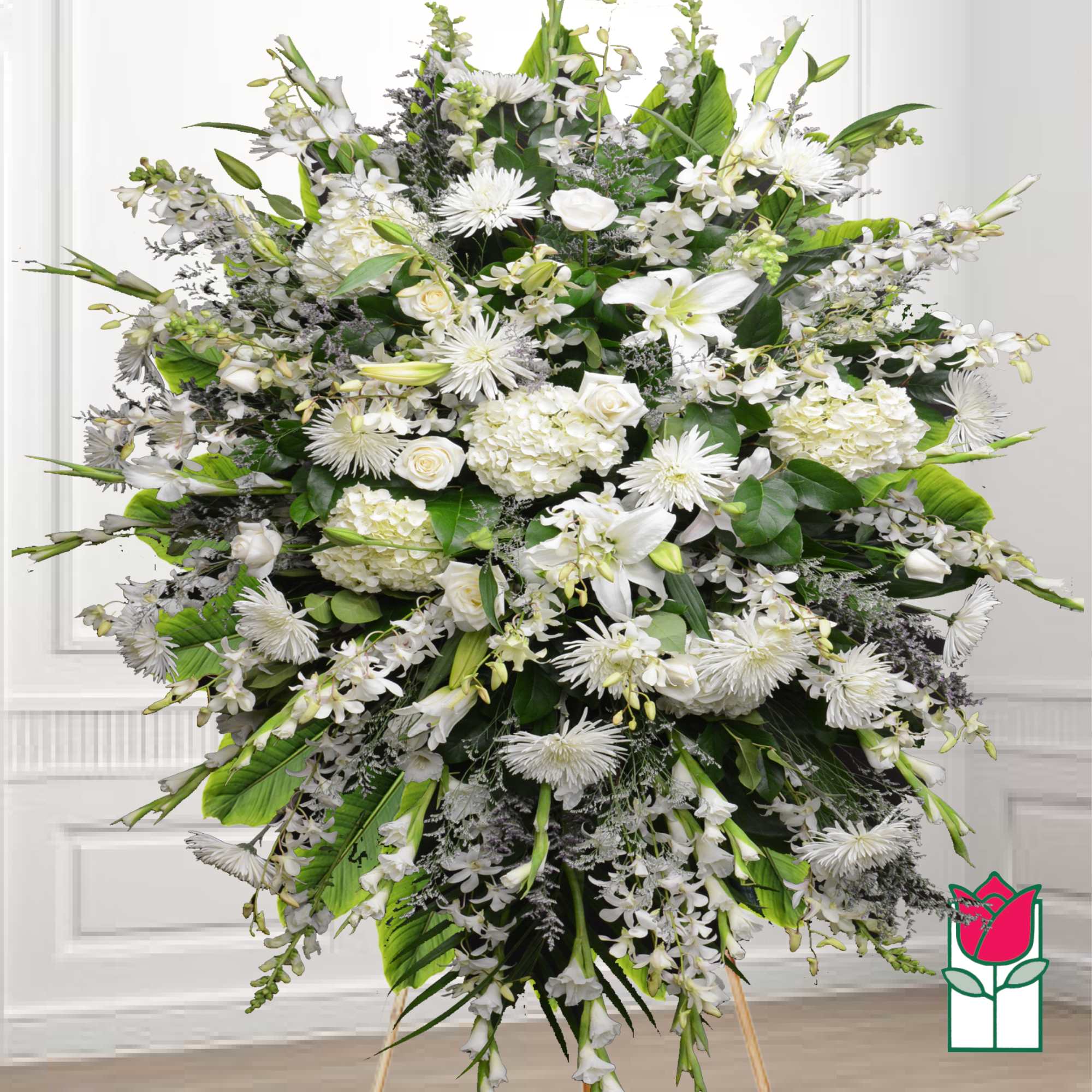Large white funeral spray with lilies, roses, and chrysanthemums