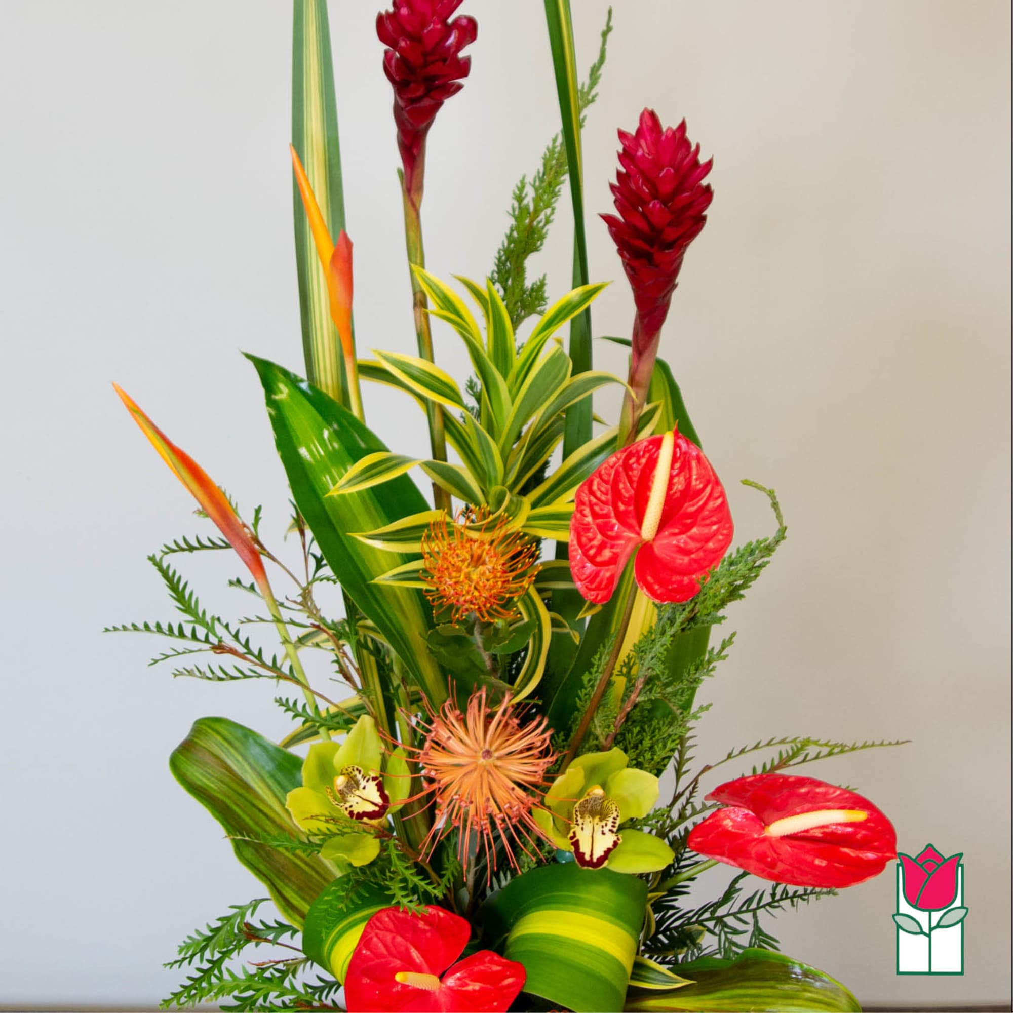 Tropical arrangement with red anthuriums and orange-red exotic blooms