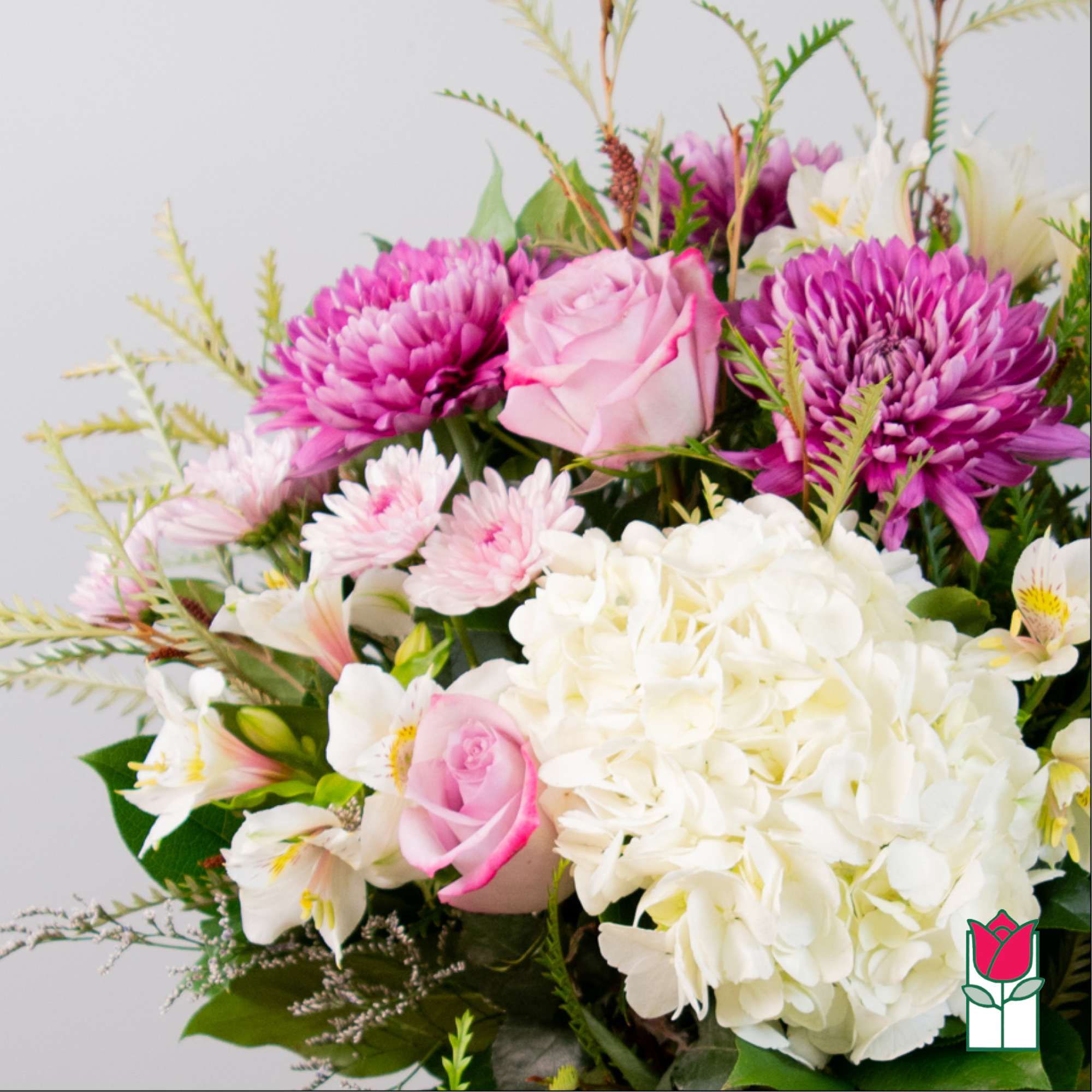 Bouquet of pink and white flowers with a large white hydrangea bloom