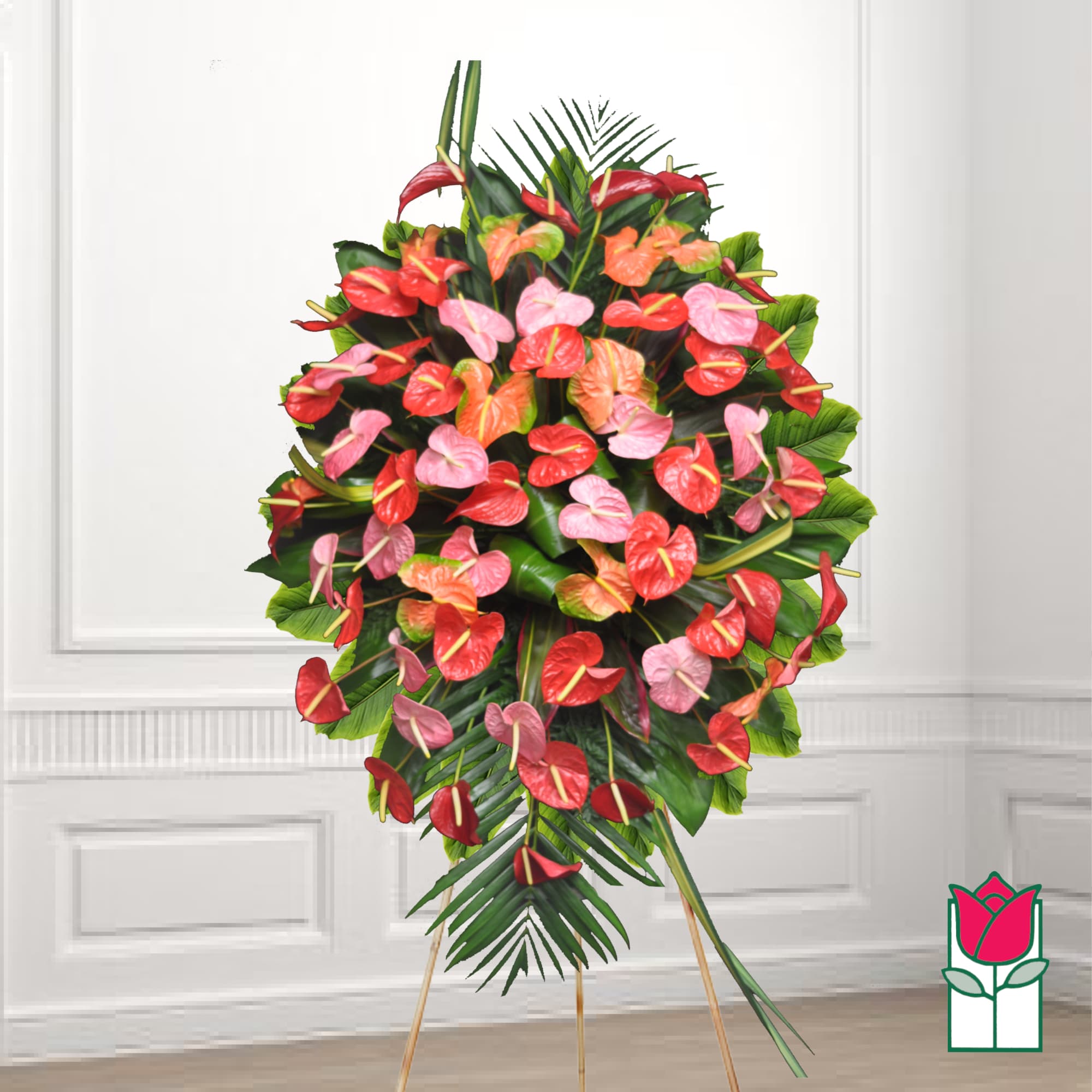 Standing floral spray of red and pink anthuriums with tropical leaves