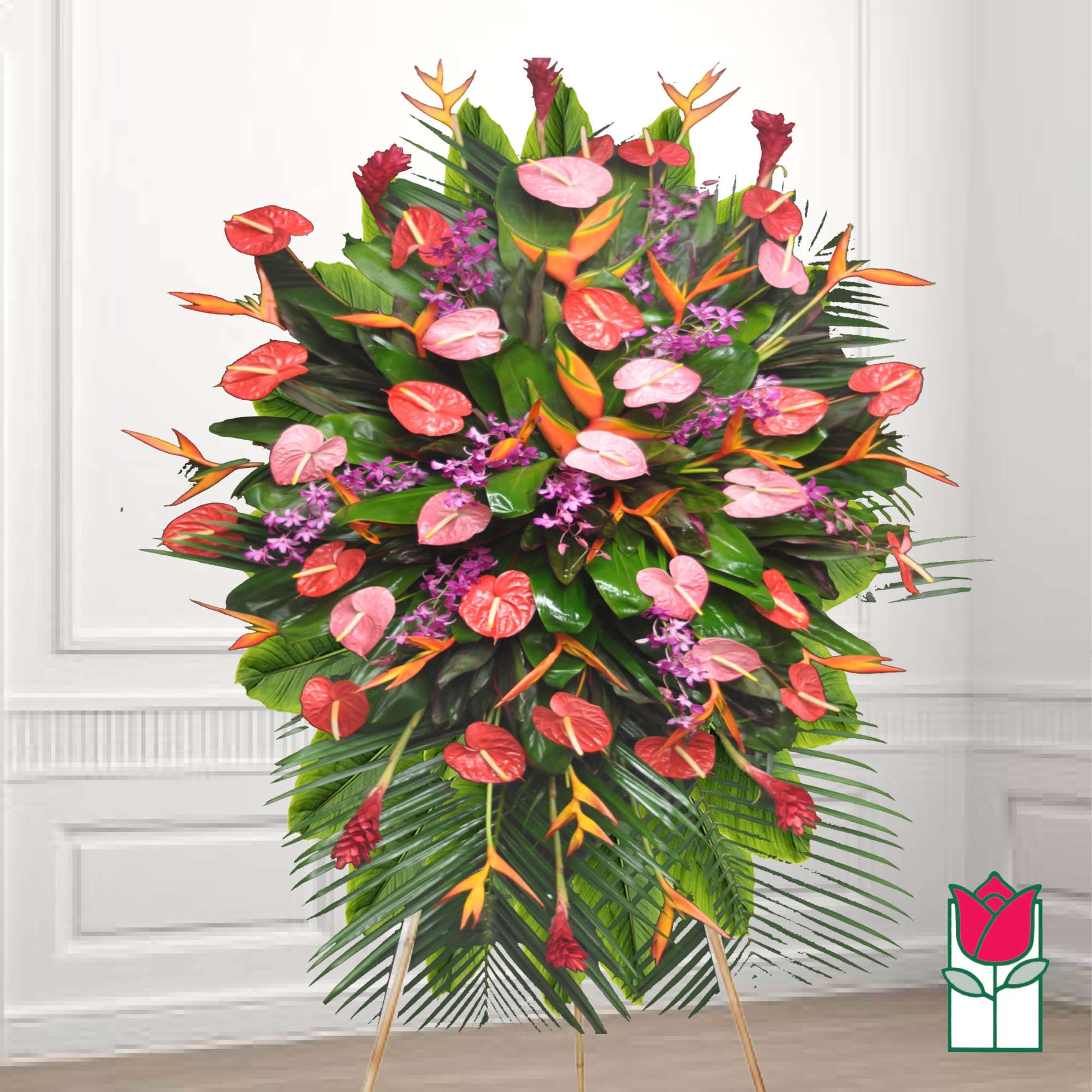 Large tropical standing floral arrangement with red, pink, and orange blooms