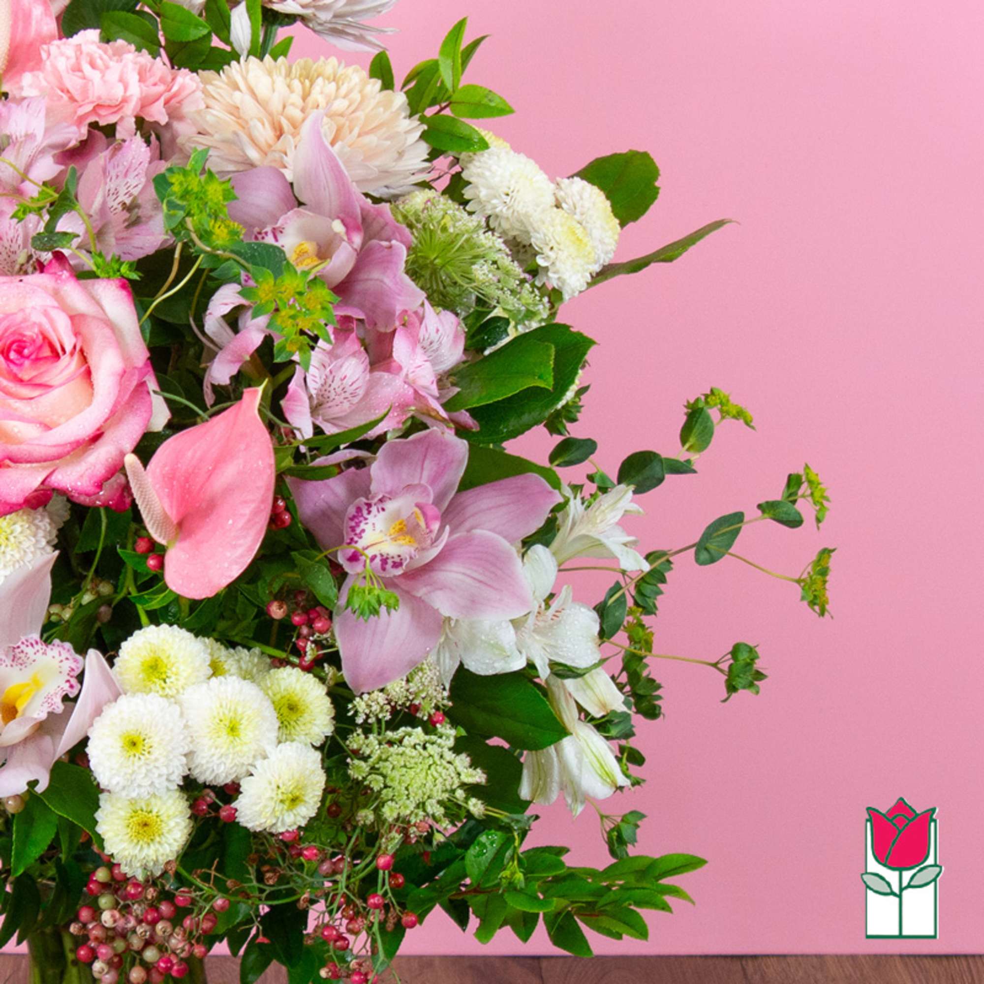 Pink and white mixed bouquet with roses and orchids on a pink background