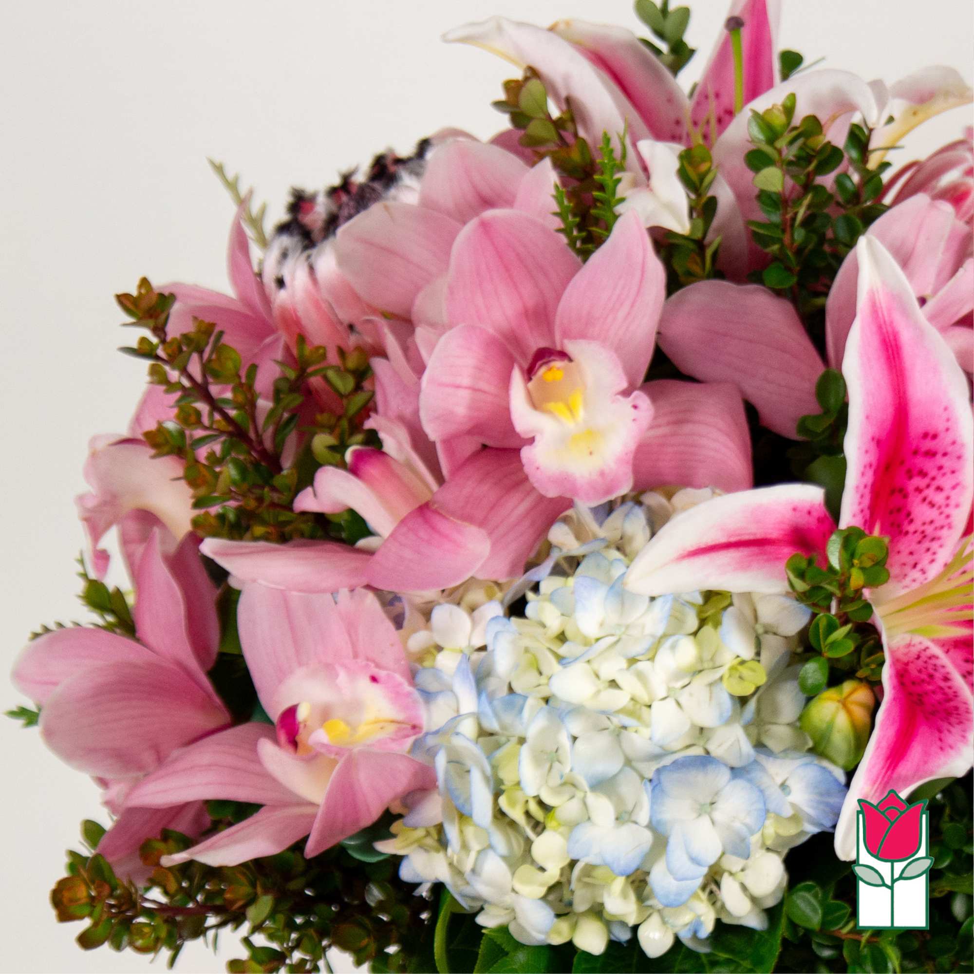 Pink lilies and hydrangeas arranged in a bouquet