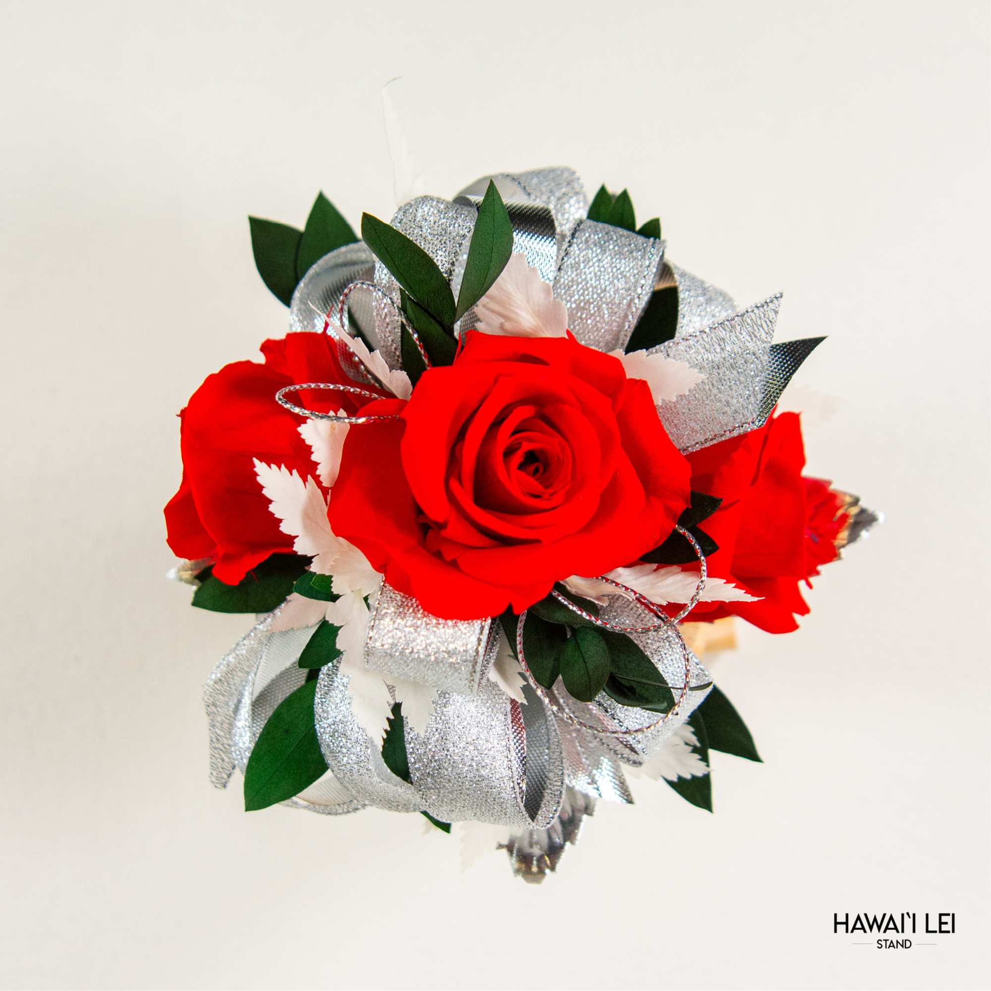 Red rose bouquet with silver ribbon and green leaves