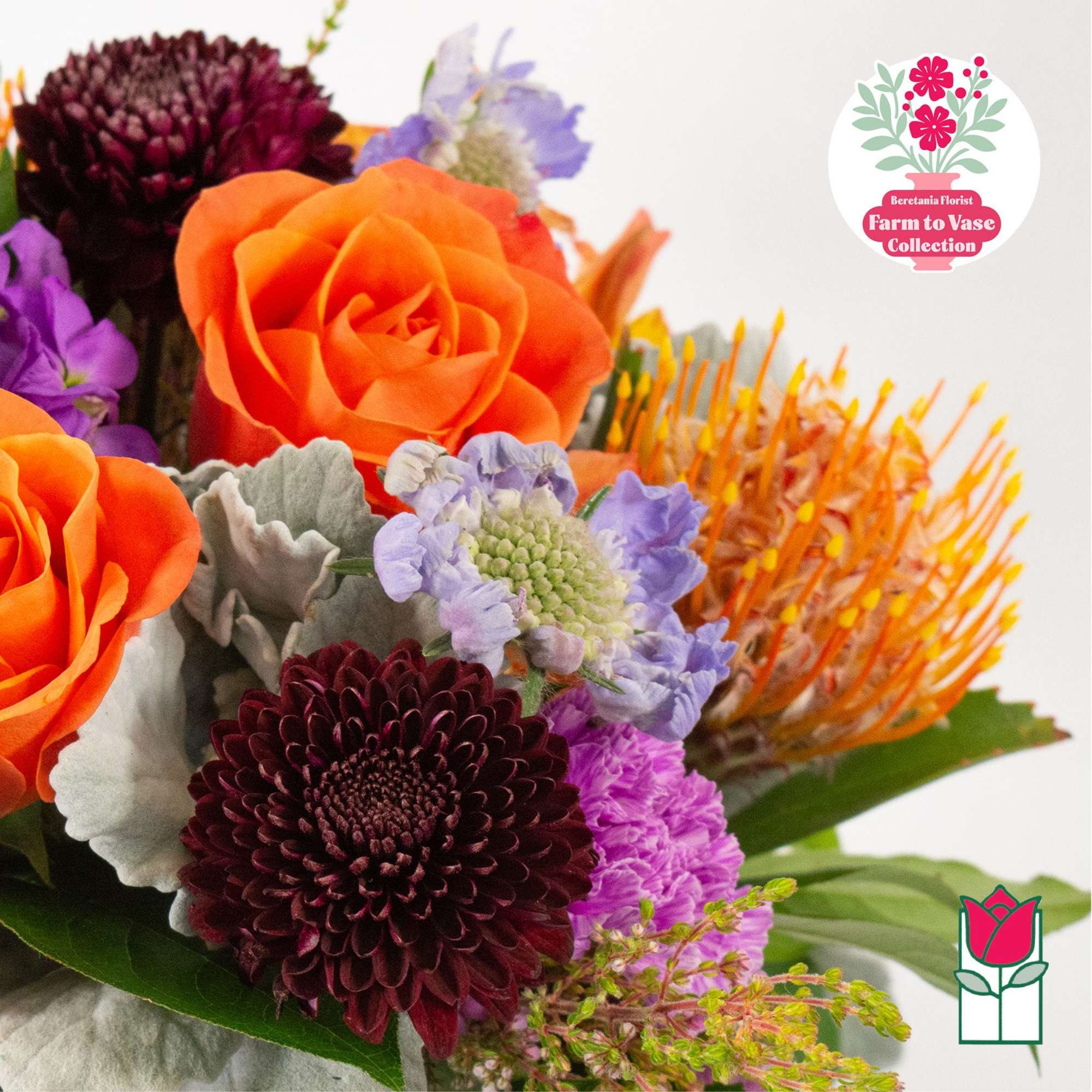 Bouquet with orange roses, dark burgundy chrysanthemums, and purple flowers