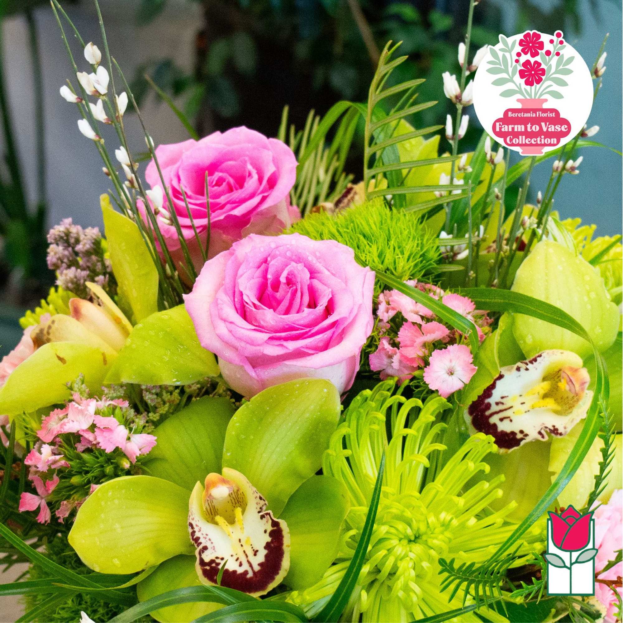 Pink roses with green orchids and small pink flowers in a bouquet