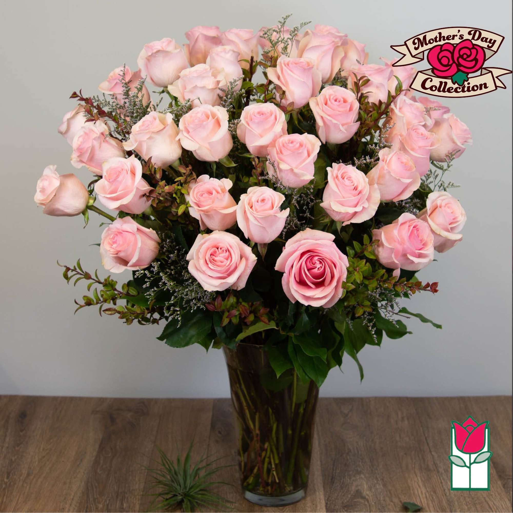 Pink roses arranged in a tall glass vase