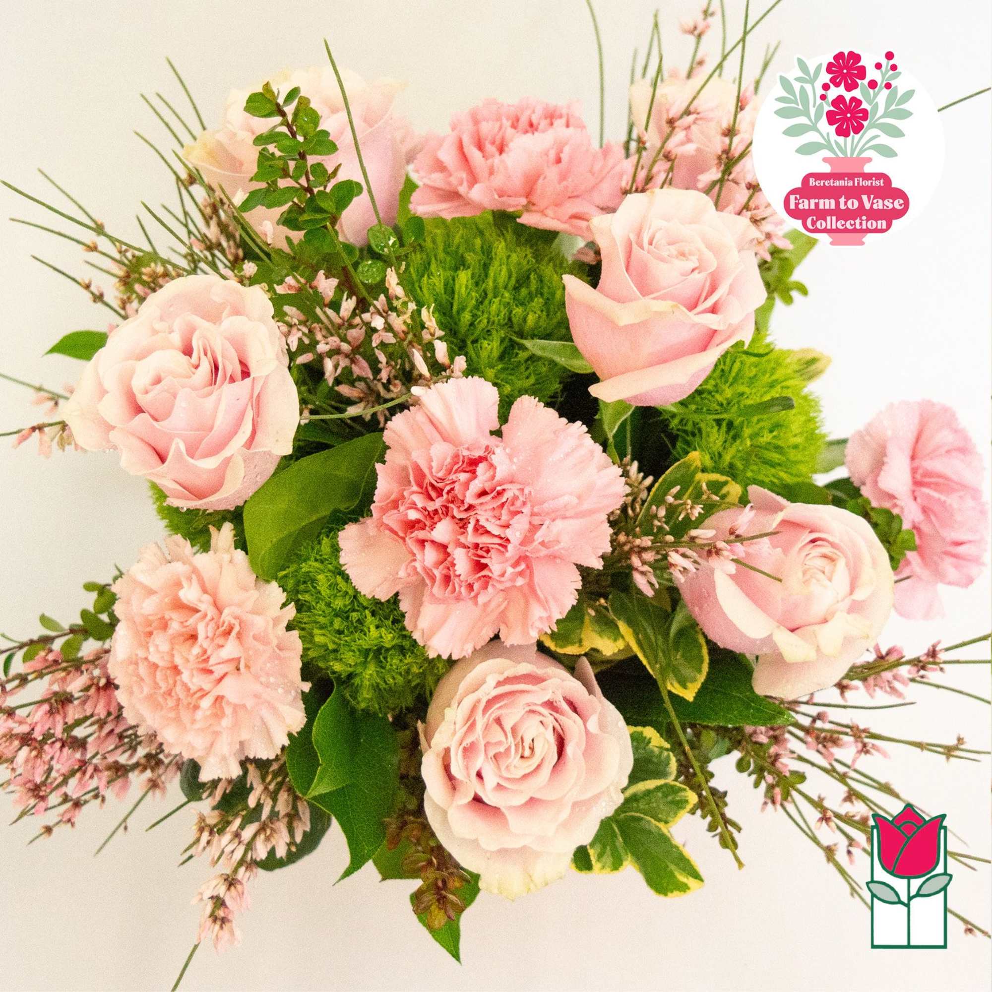 Pink roses and carnations arranged with greenery in a bouquet, photo 3 of 7