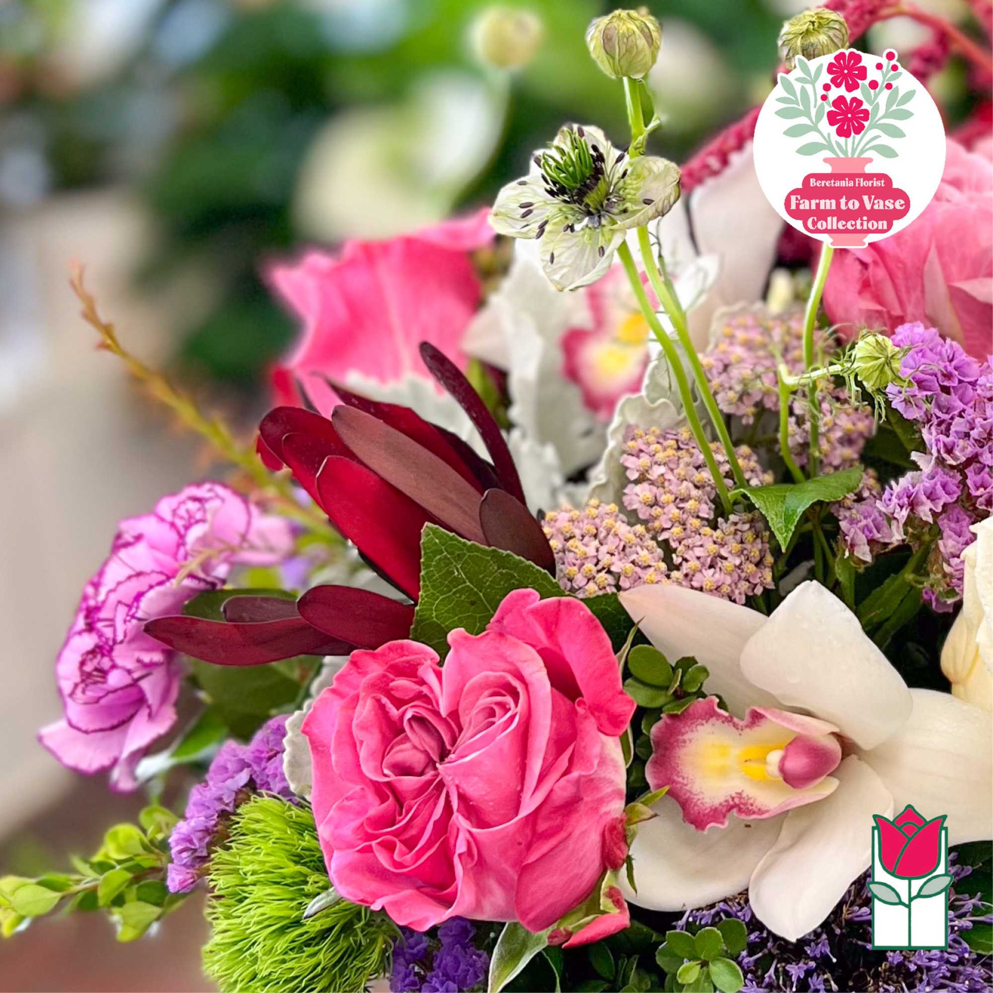 Mixed bouquet with pink roses, white orchids, and purple flowers