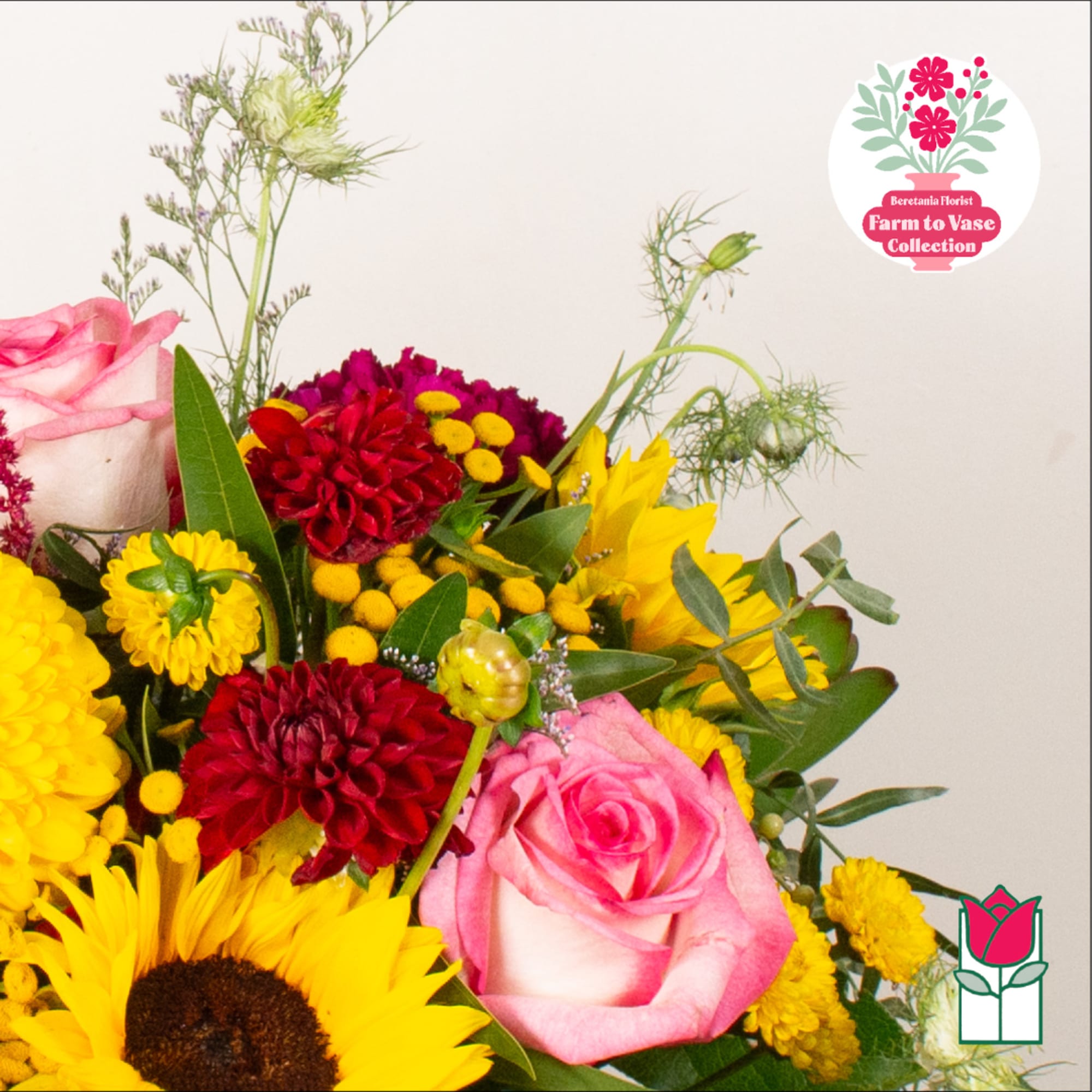 Bouquet of pink roses, red and yellow flowers, and sunflowers