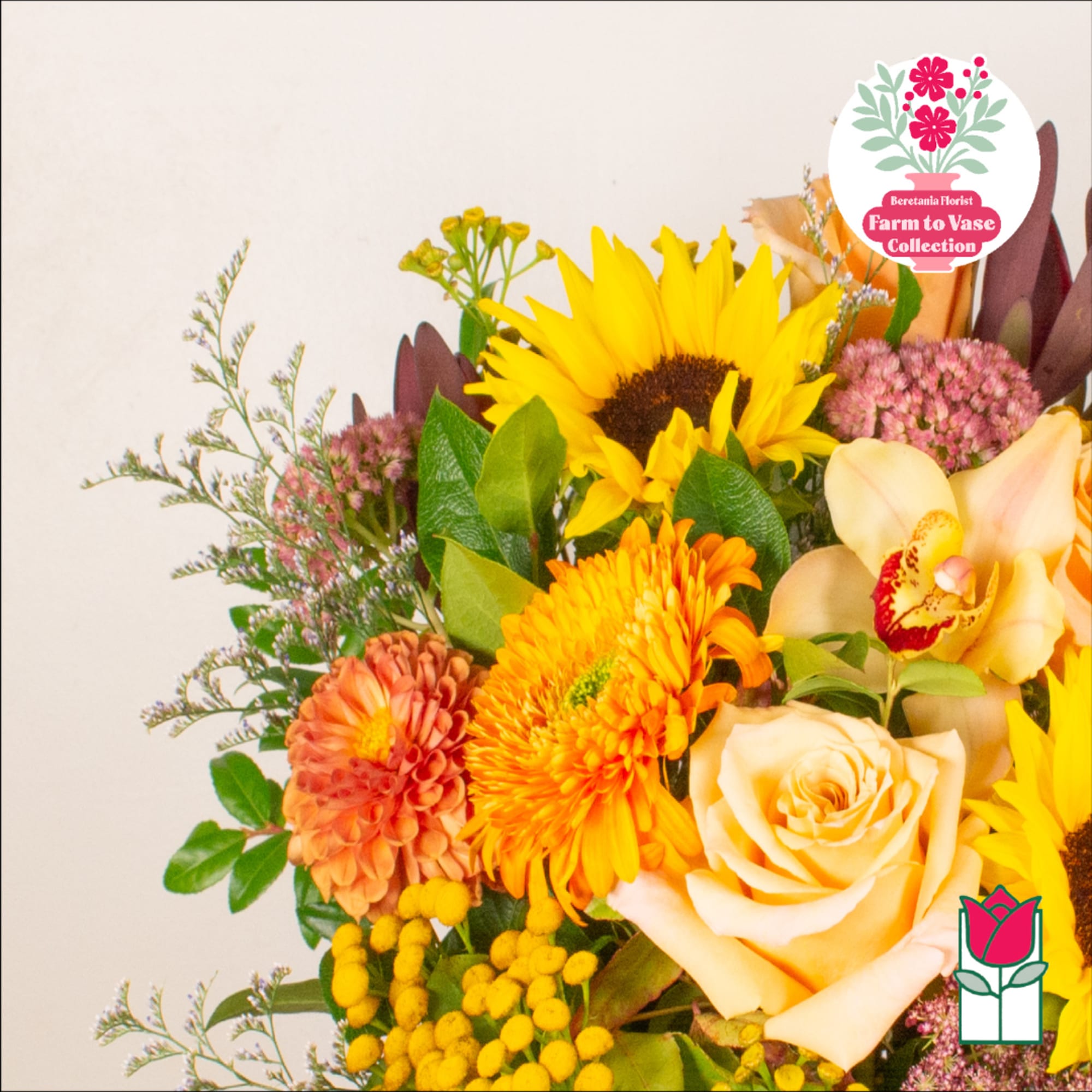 Bouquet with sunflowers, roses, and orange blooms in a mixed arrangement