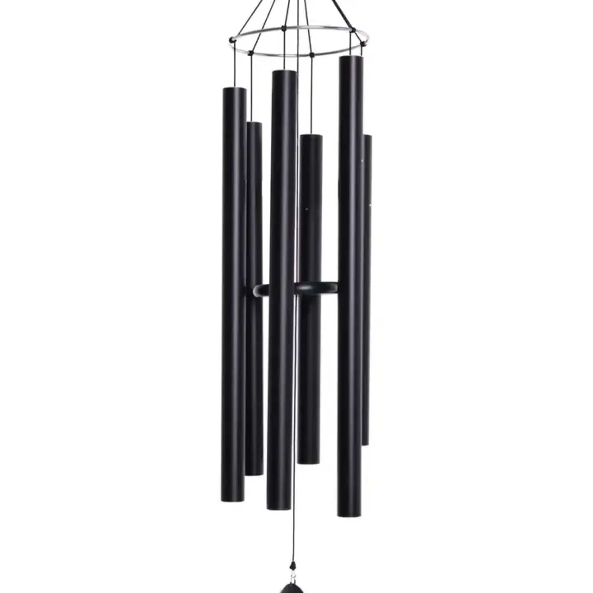 Tall black metal wind chime with multiple tubular chimes hanging in a cluster
