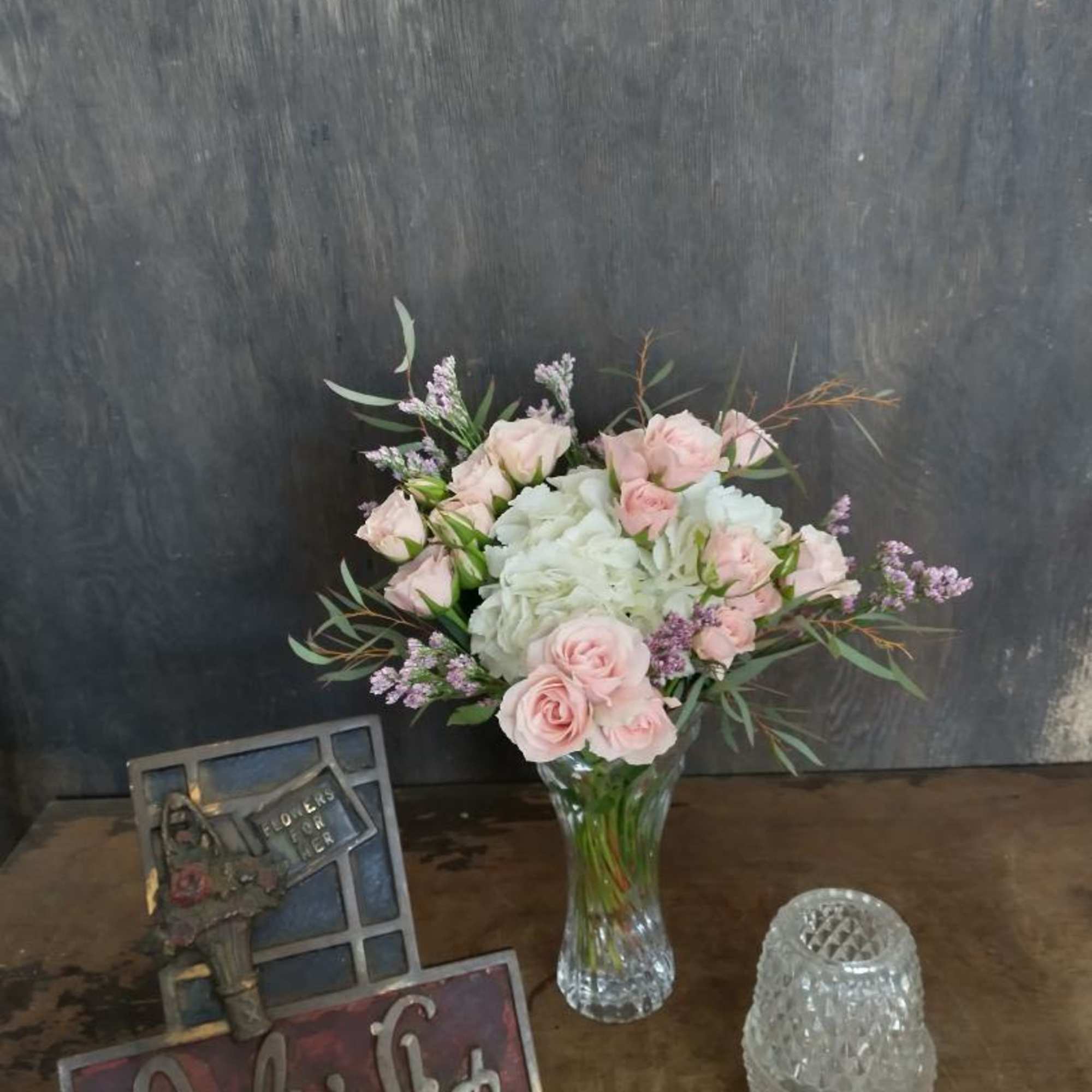 Pink roses and white hydrangeas in a clear glass vase, photo 2 of 2