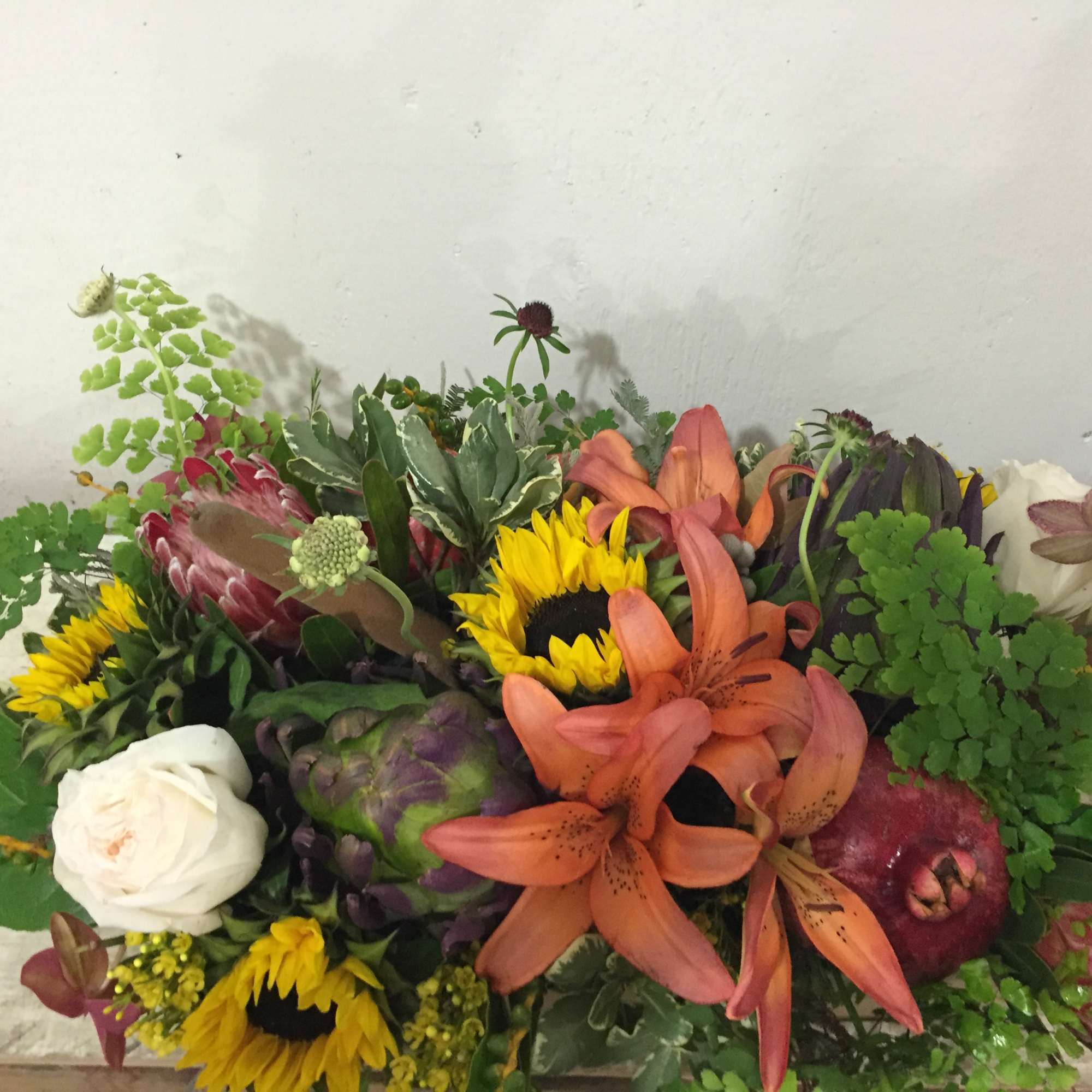 Mixed bouquet with sunflowers, lilies, roses, and greenery
