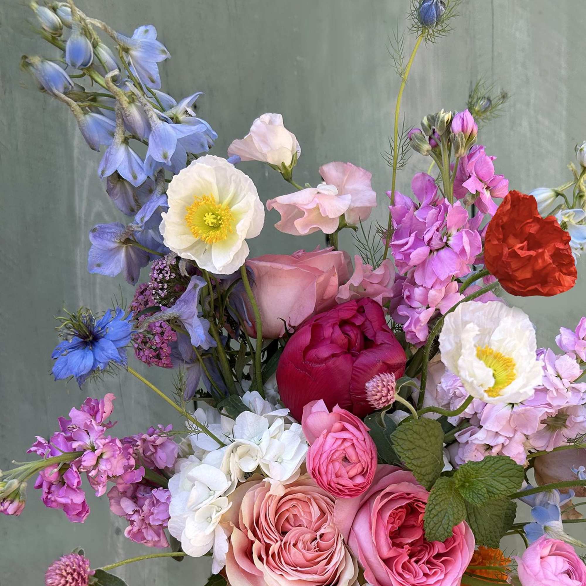 Mixed bouquet of pink, blue, white, and red flowers