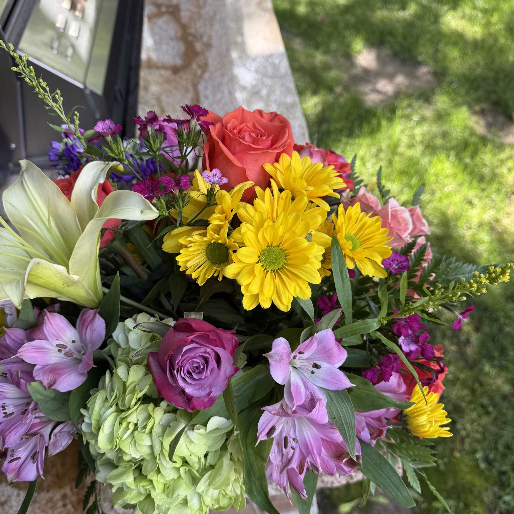 Colorful mixed bouquet with roses, lilies, daisies, and hydrangea