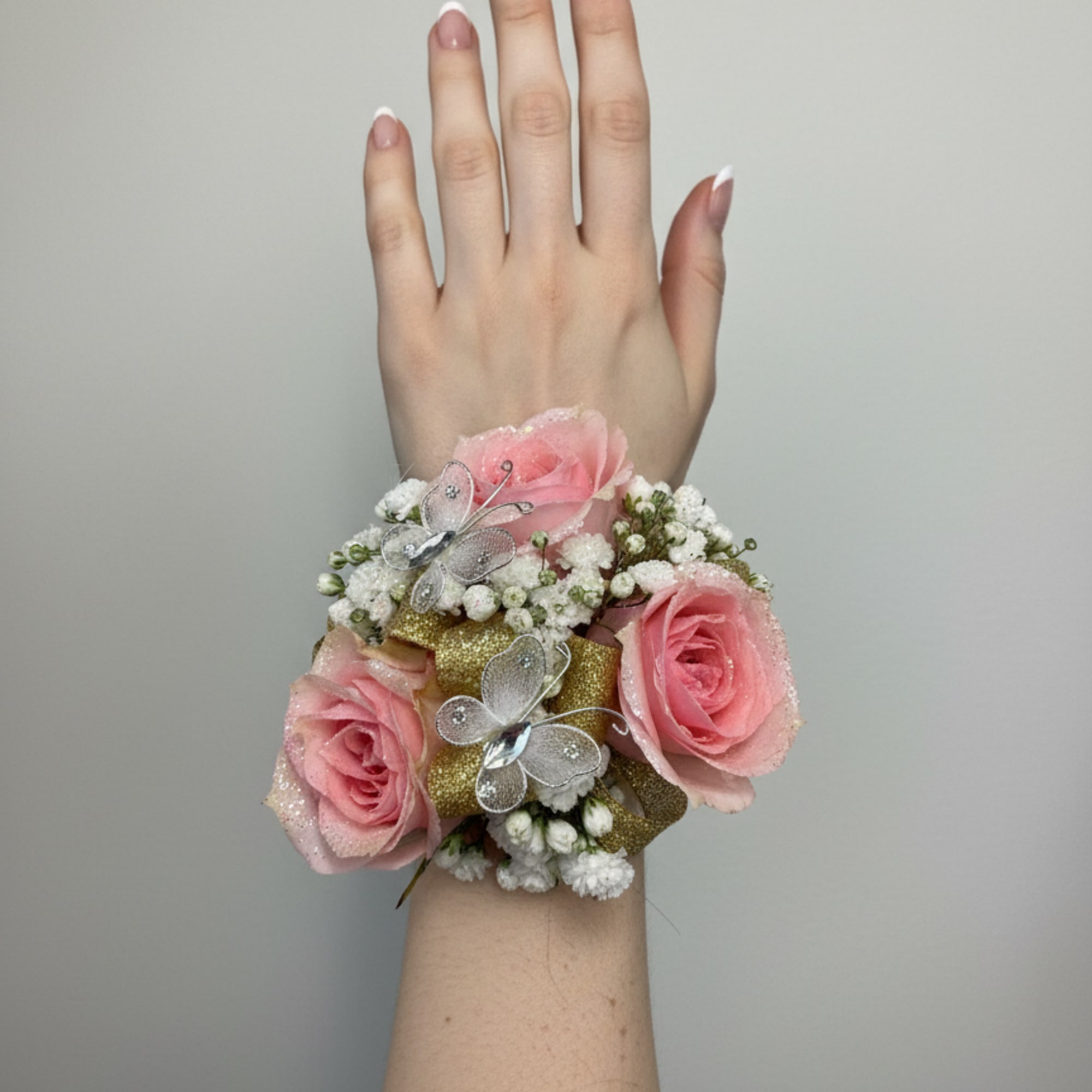 The perfect corsage for your "Golden Sweetheart" with three pink baby roses
