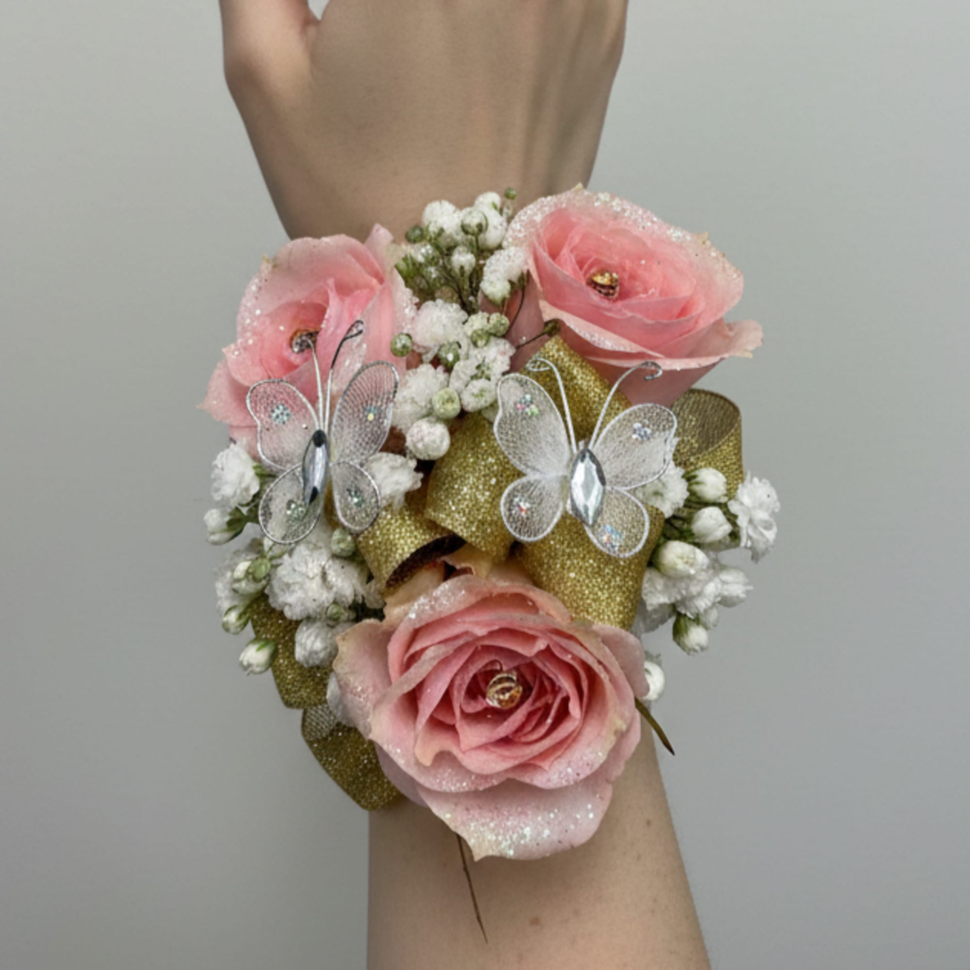 The perfect corsage for your "Golden Sweetheart" with three pink baby roses