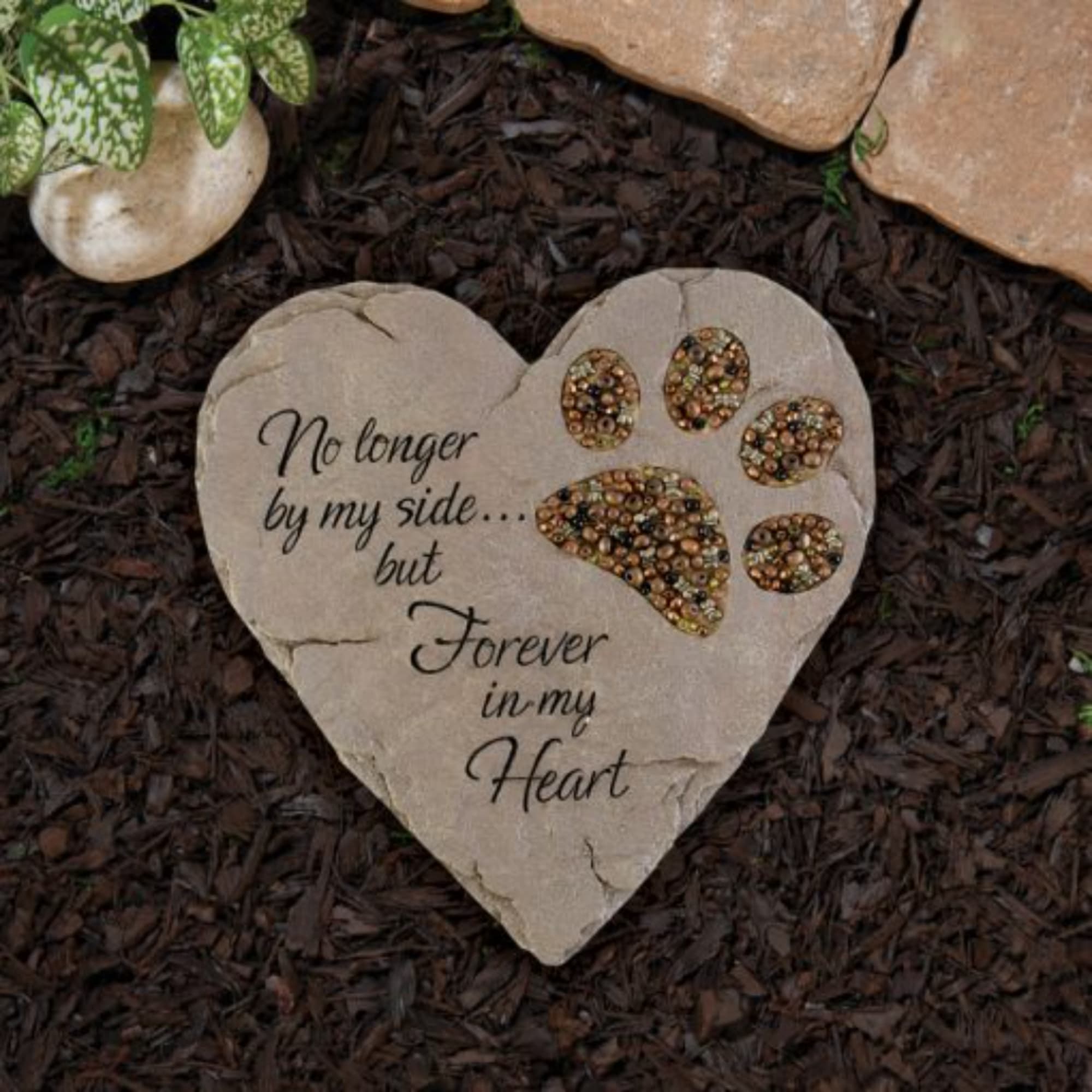 Heart-shaped memorial stone with paw print and sympathy text
