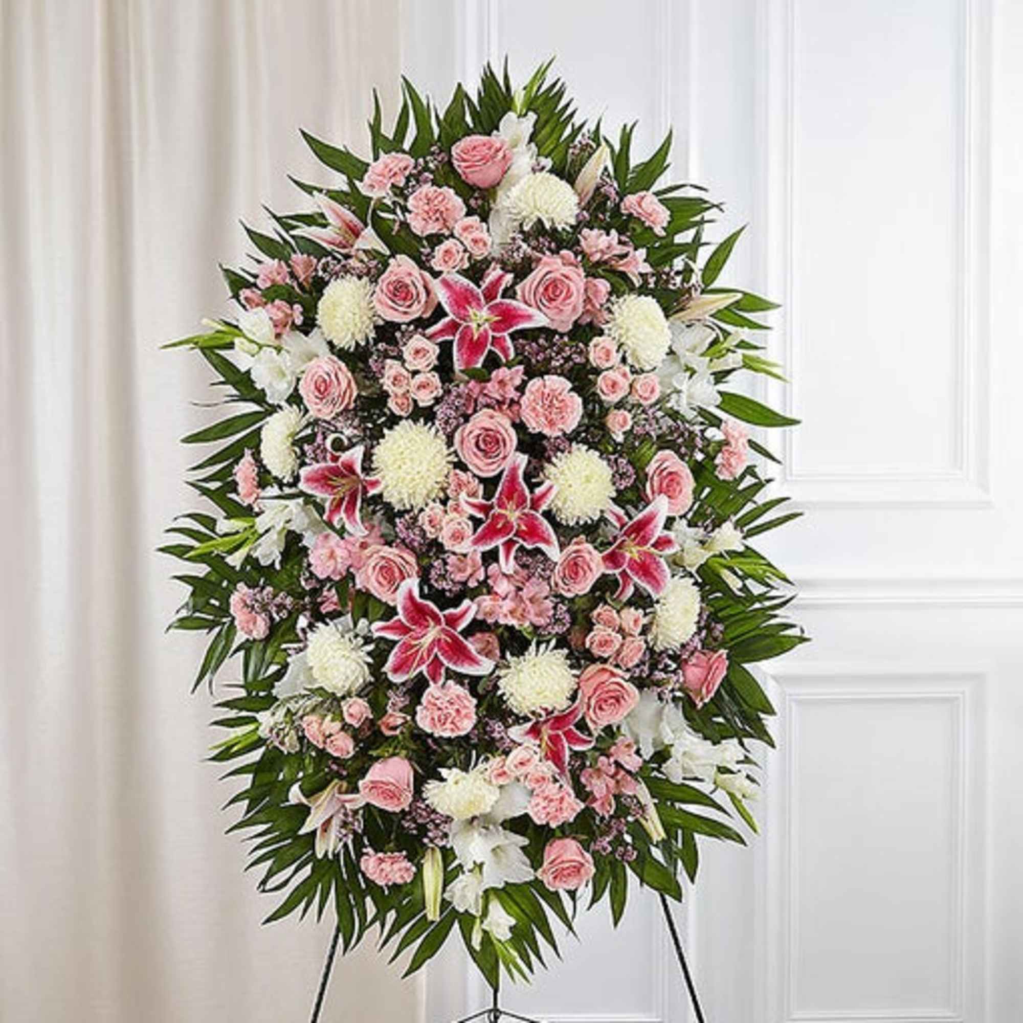 Standing floral spray with pink and white flowers on an easel