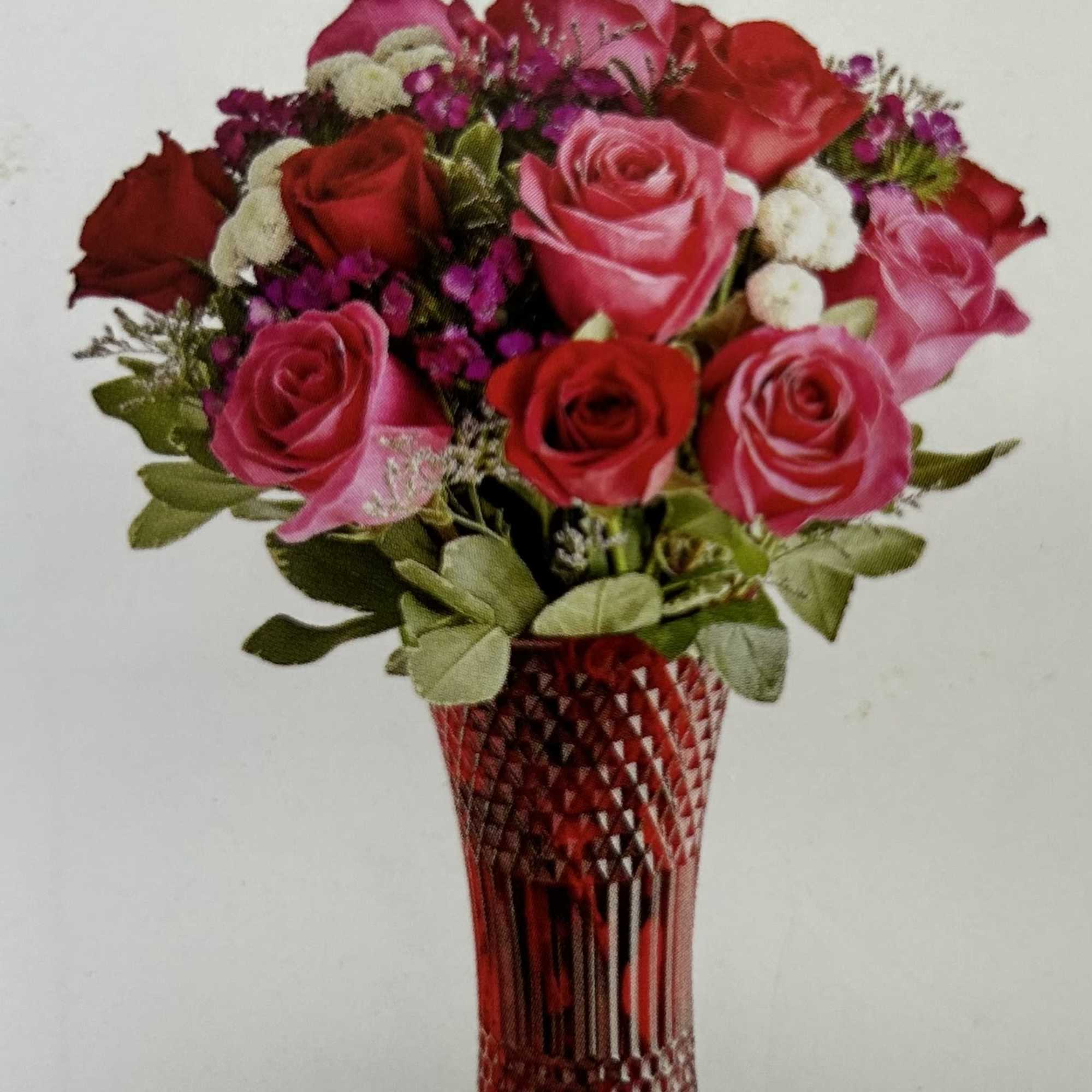 Bouquet of red and pink roses in a red cut-glass vase