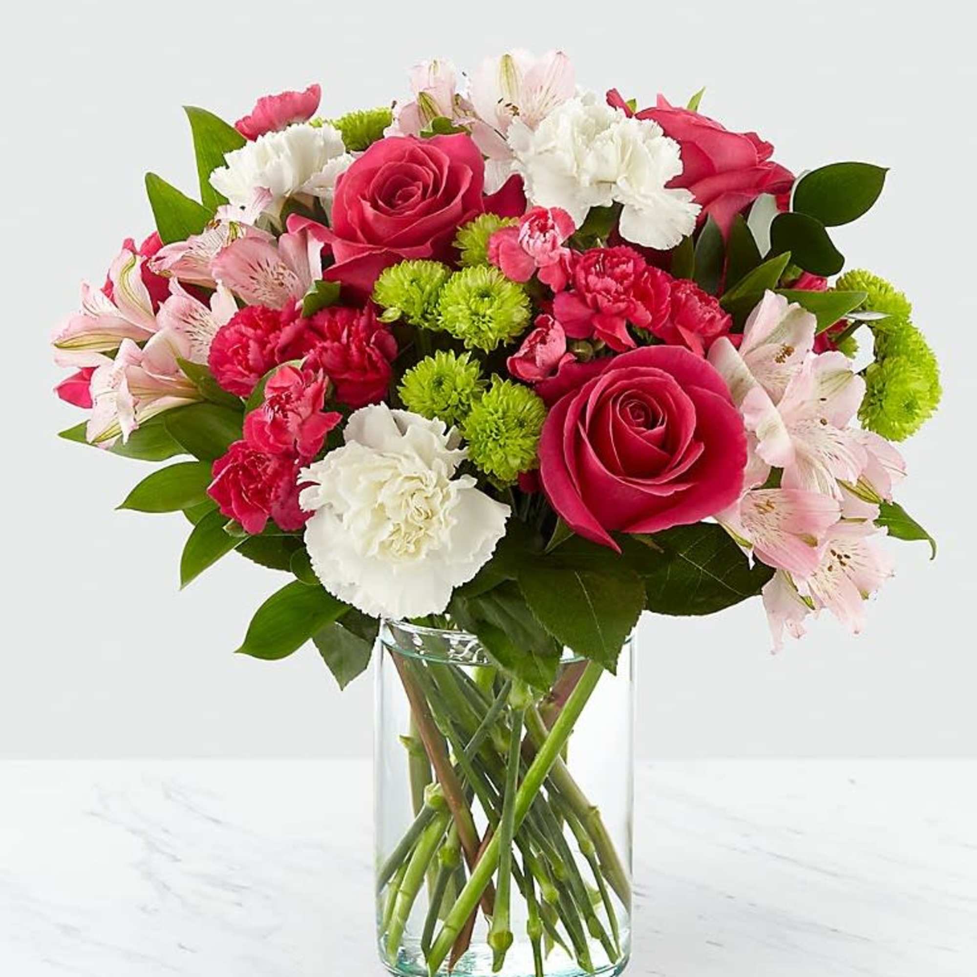 Pink and white mixed bouquet in a clear glass vase