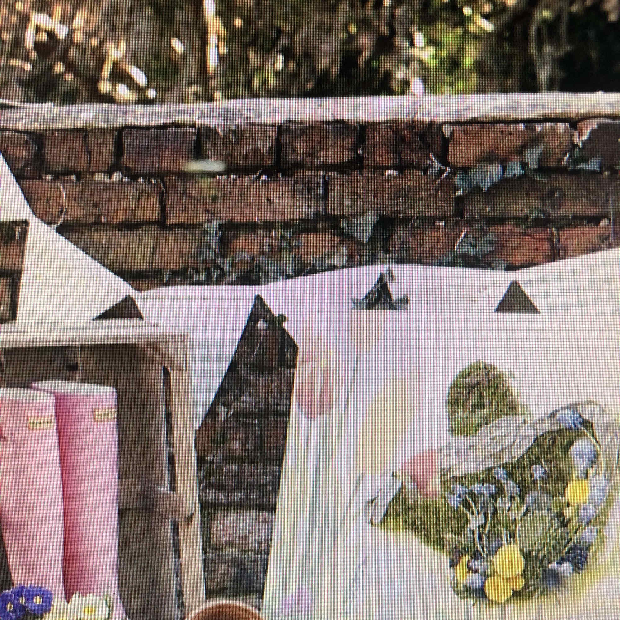 White tote with a small floral arrangement and pink candles nearby