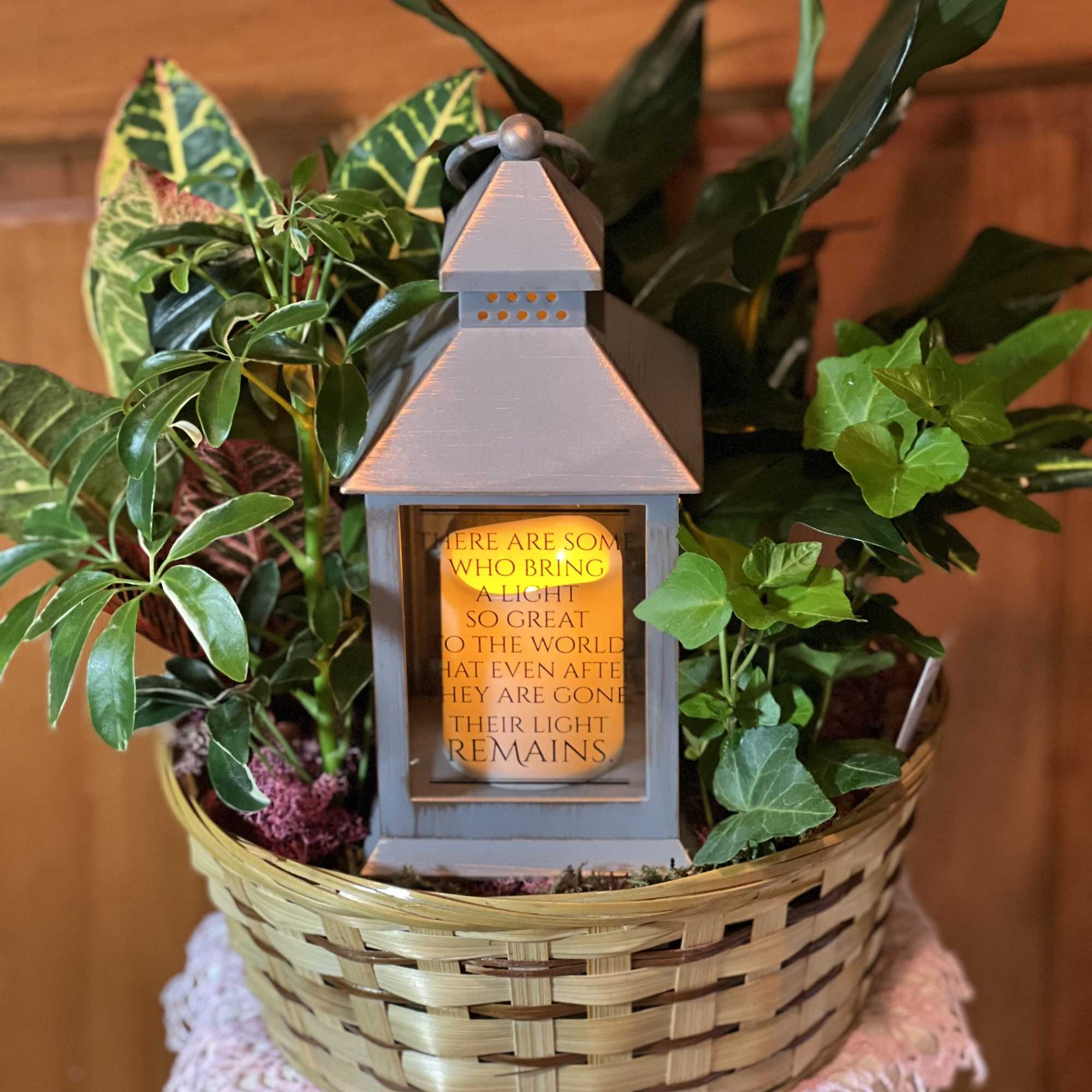 Basket of potted plants with a decorative lantern candle