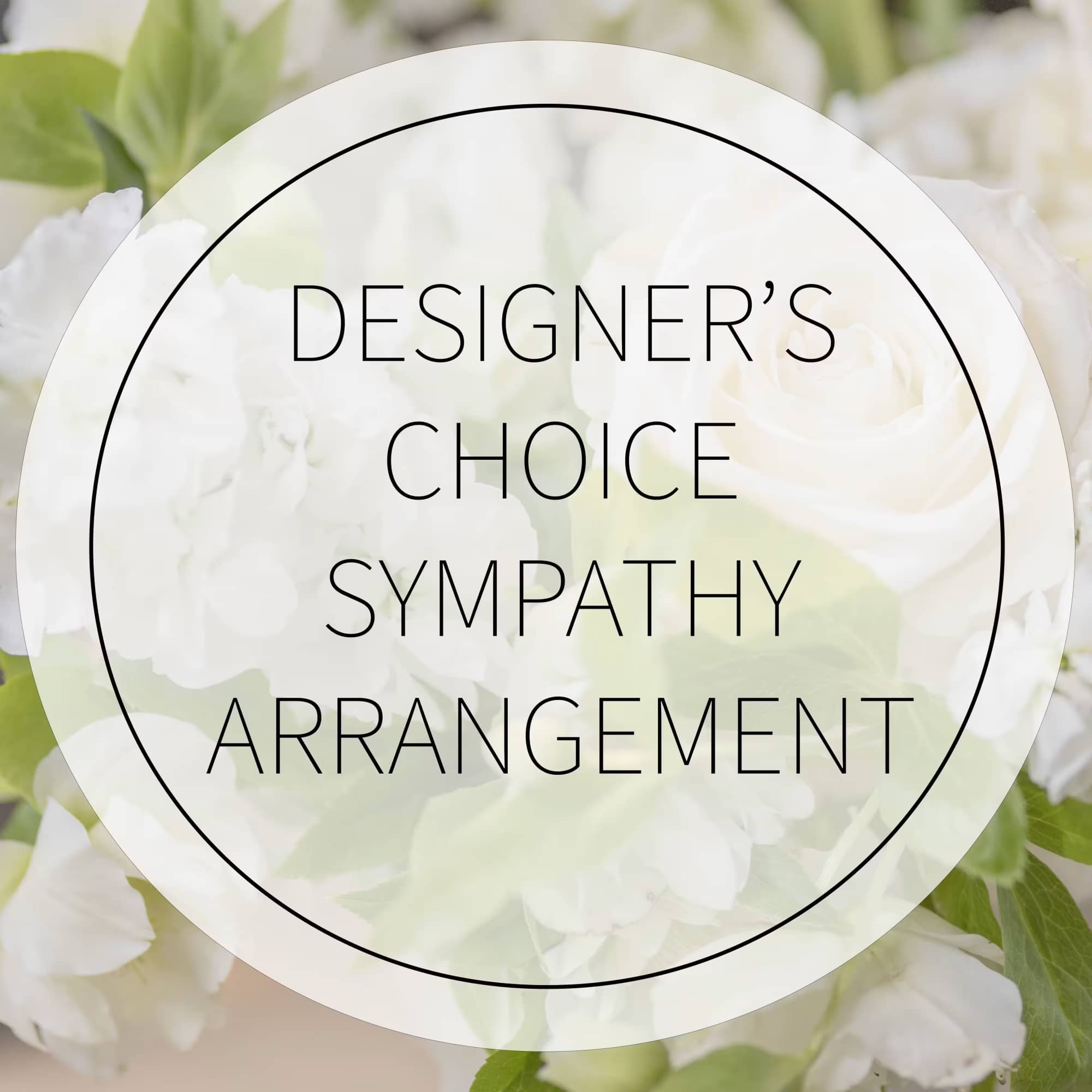 White floral sympathy arrangement with green foliage and a circular label