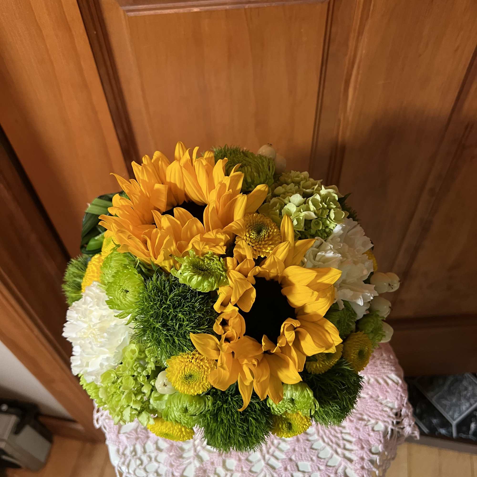 Two tall sunflowers rise above a compact, rounded centerpiece-an upbeat flower arrangement, photo 2 of 2