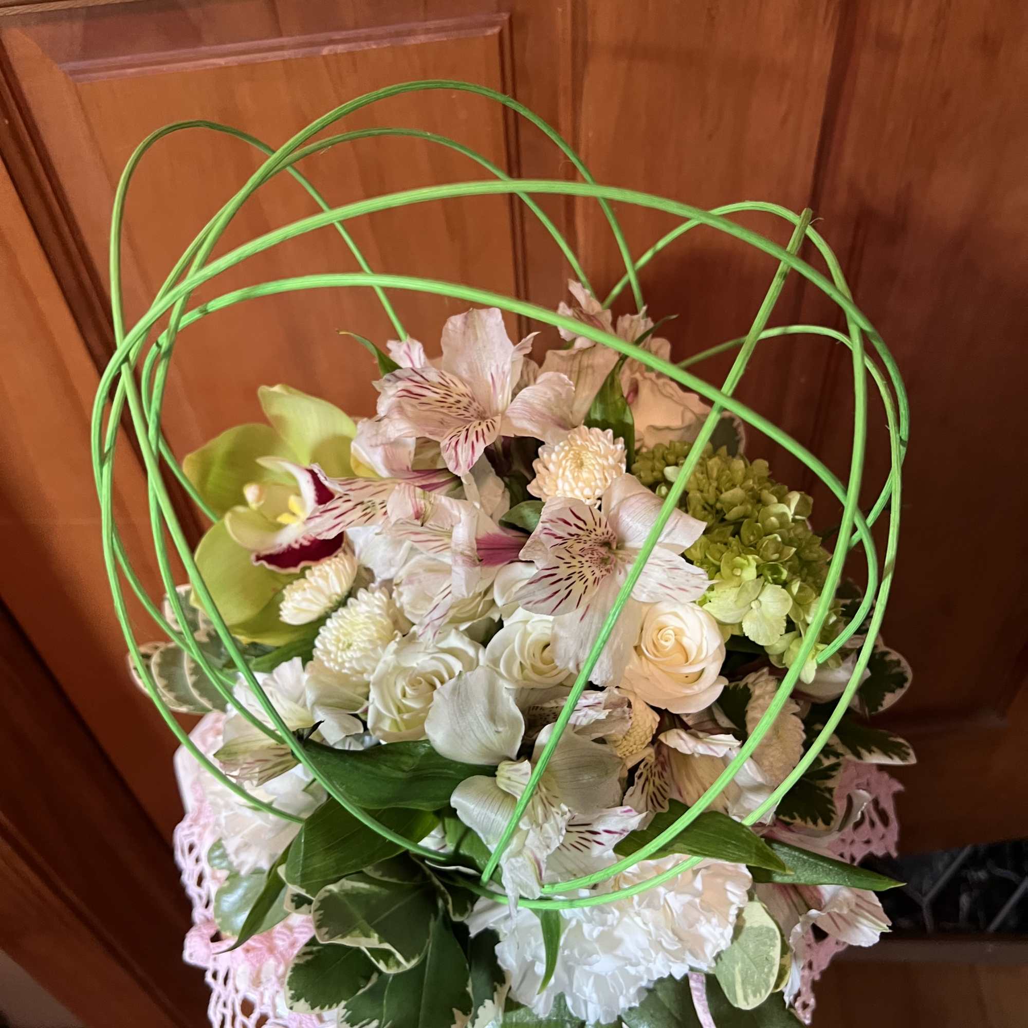 Mixed floral arrangement with white and pale pink blooms in a decorative vase