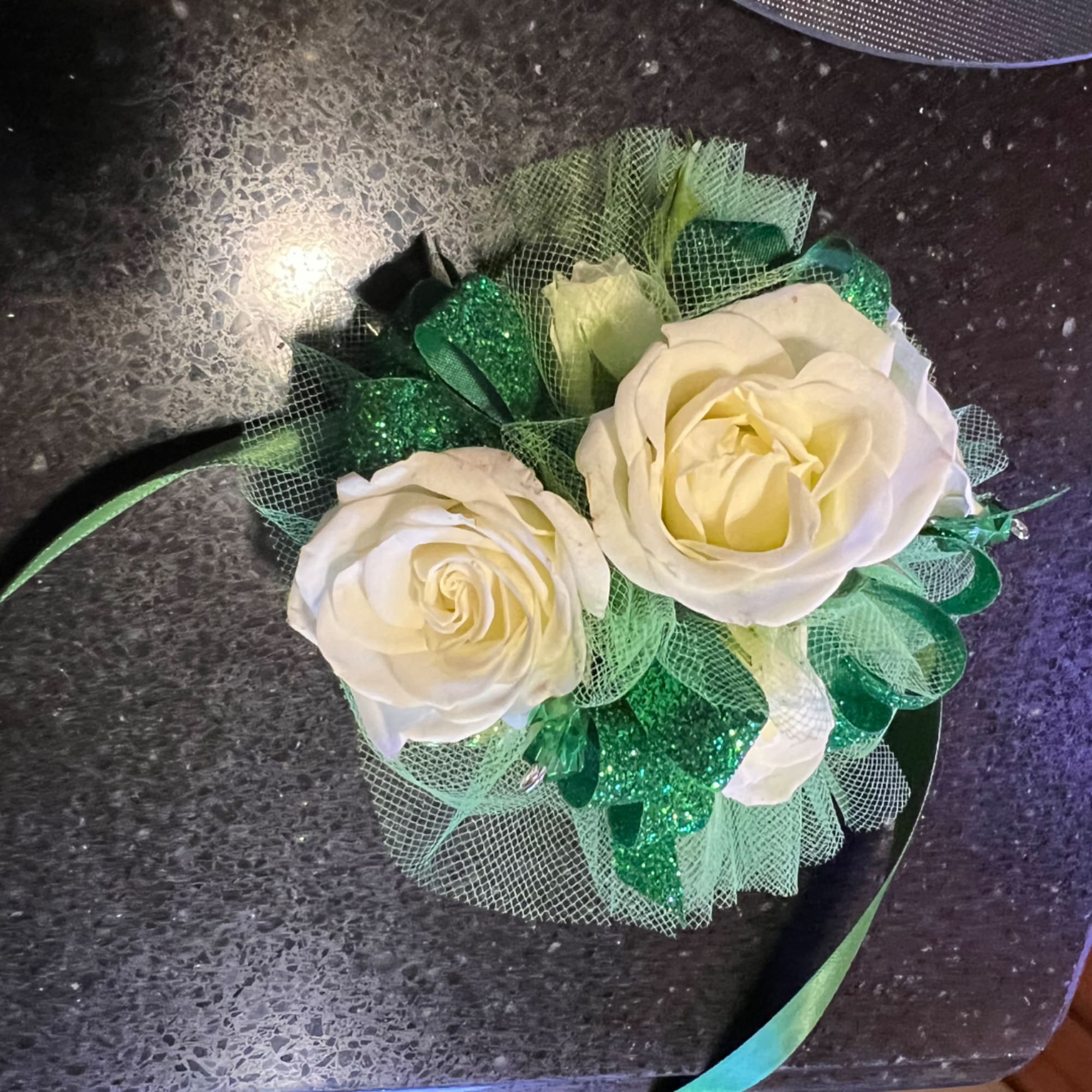Two cream roses with green ribbon and mesh wrap