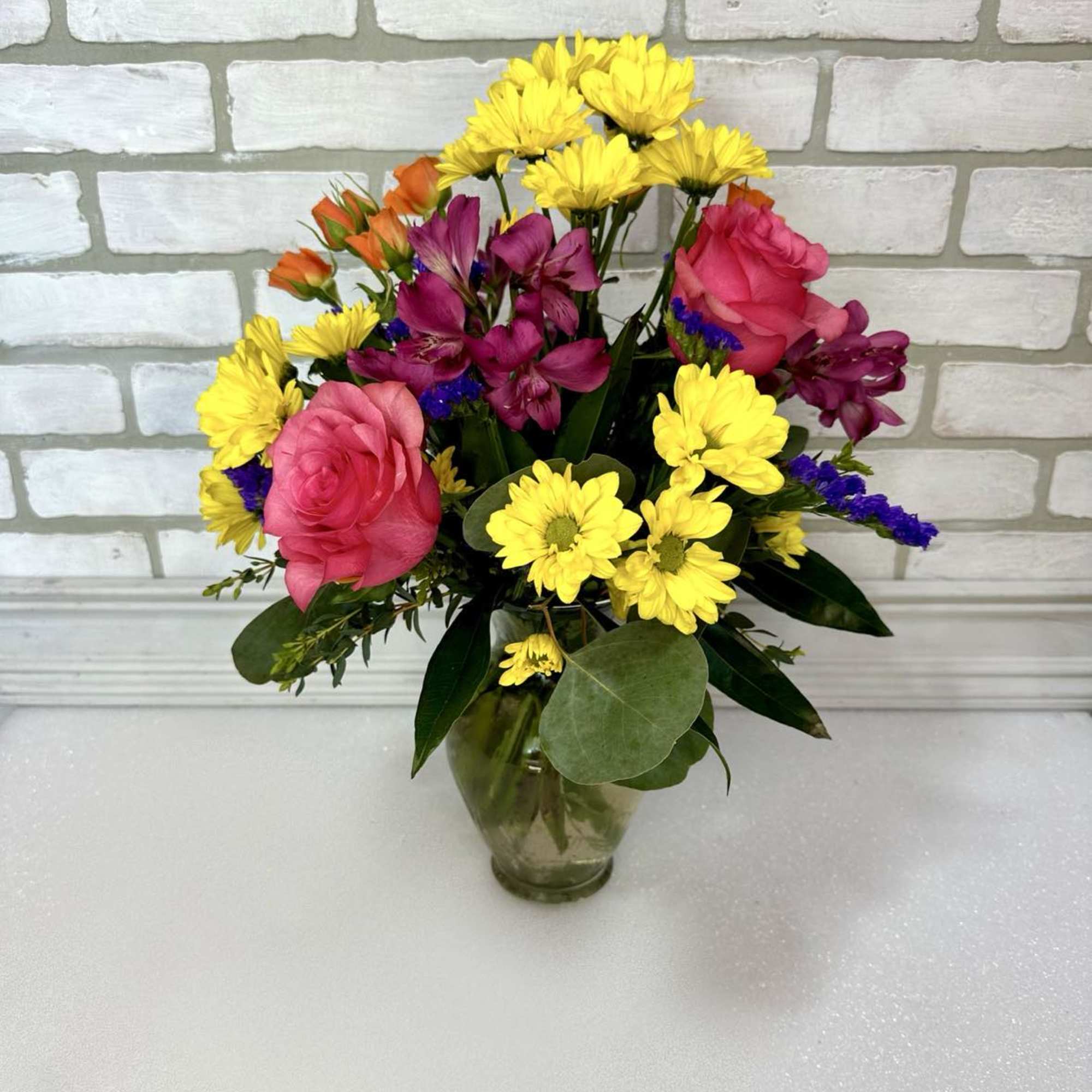 Happiness in a vase! A cheerful bouquet of assorted blooms arranged in