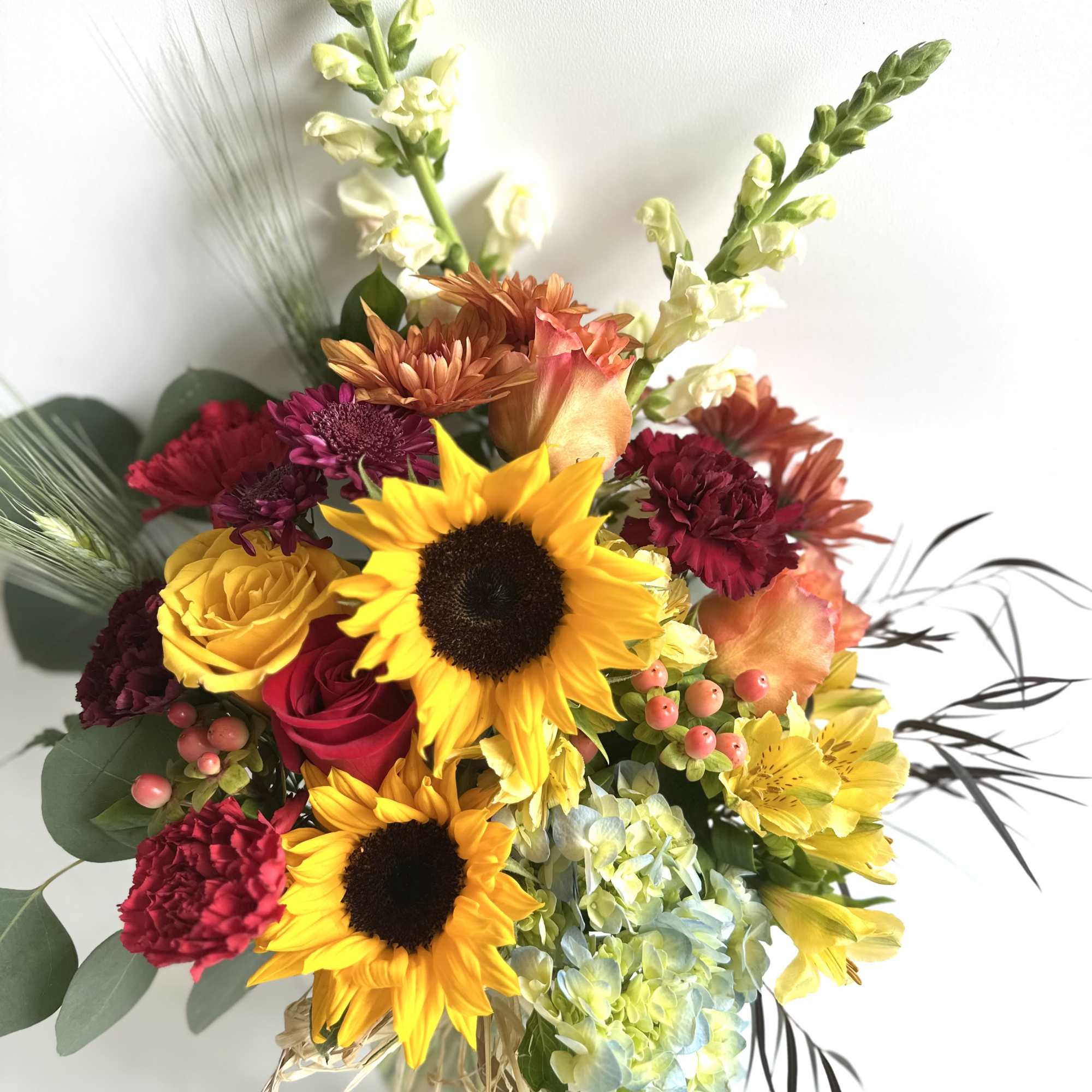 Mixed bouquet with sunflowers, roses, carnations, and hydrangea